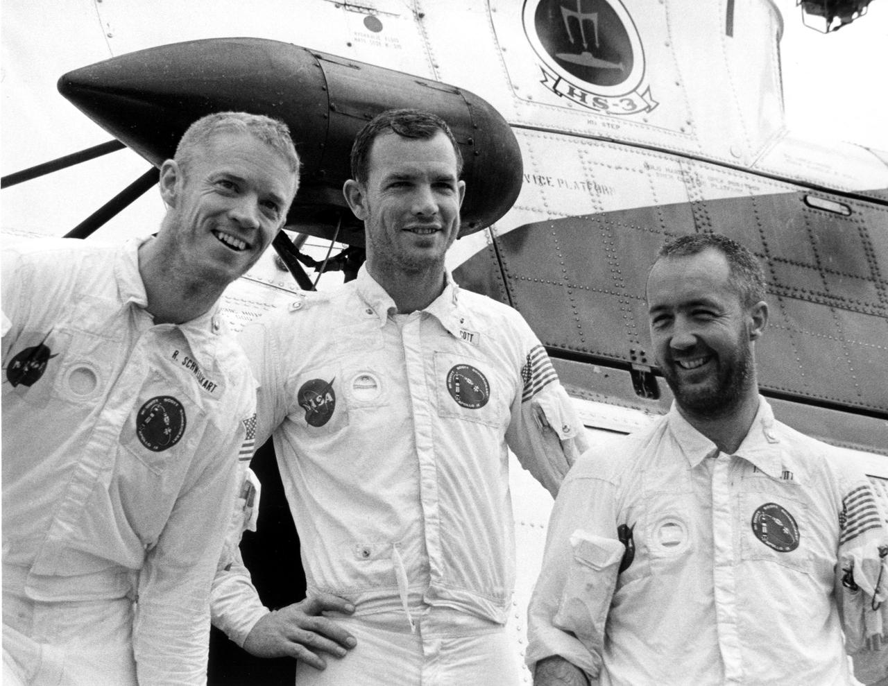 KENNEDY SPACE CENTER, FLA. -- Bearded and smiling, Apollo 9 astronauts, left to right, Russell L. Schweickart, David R. Scott and James A. McDivitt, pause in front of recovery helicopter, which carried them a short distance from their spacecraft's impact point to the USS Guadalcanal, prime recovery ship. They splashed down today less than five miles from the Guadalcanal, 780 nautical miles southeast of Cape Kennedy. The astronauts reentered at the beginning of their 152nd Earth orbit following a textbook flight that verified a lunar module spacecraft. It was similar to the one that is to land Americans on the Moon later this year. They were launched March 3, 1969, from the Kennedy Space Center aboard an Apollo_Saturn V space vehicle. The National Aeronautics and Space Administration directs the Apollo program.