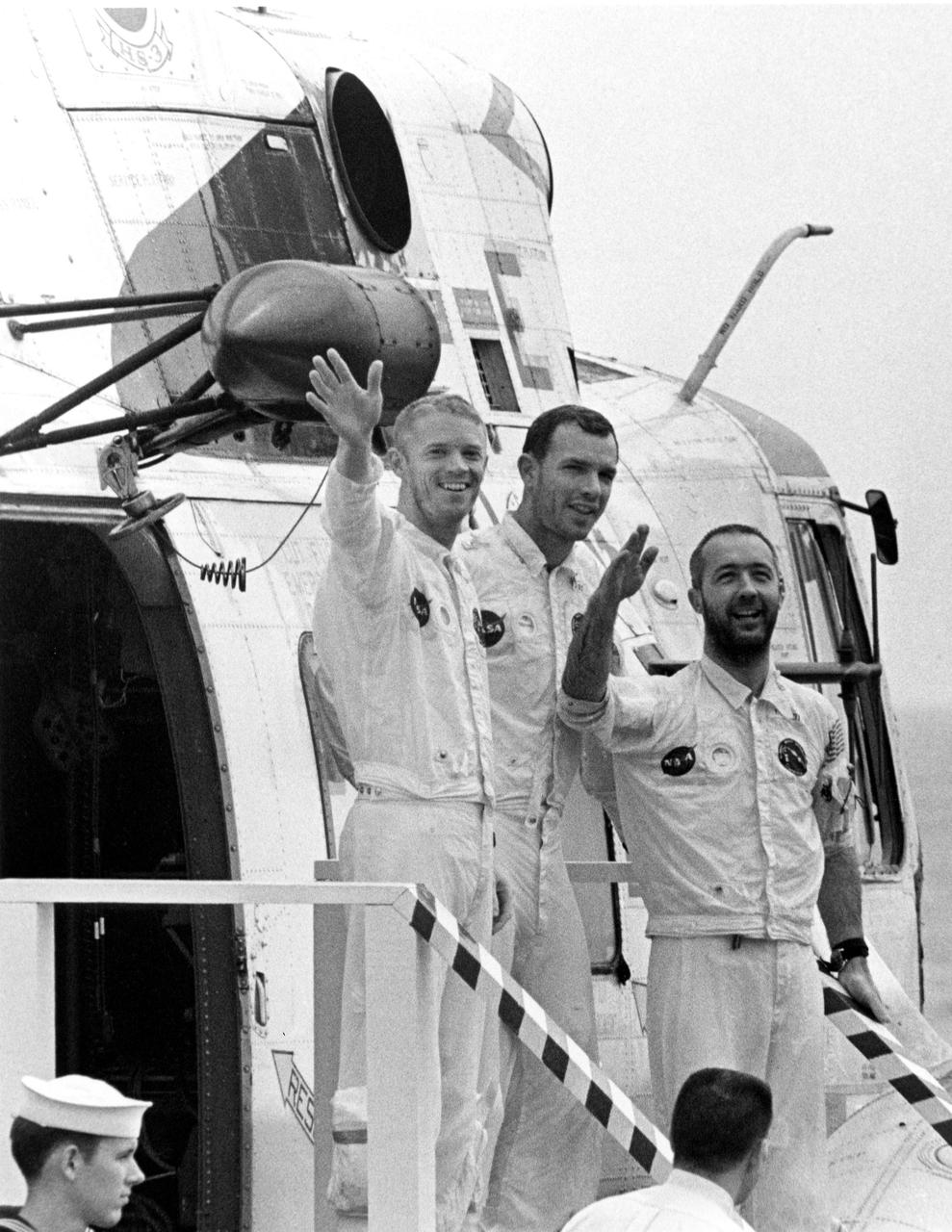 KENNEDY SPACE CENTER, FLA. -- One hour after their Apollo 9 spacecraft splashed down today in the Atlantic Ocean, waving astronauts, left to right, Russell L. Schweickart, David R. Scott and James A. McDivitt, descend stairway on to main deck of the USS Guadalcanal, prime recovery ship. The helicopter flew them from their impact point a short distance to the ship, originally positioned less than five miles from where they splashed down. The 10-day Earth orbital mission proved the feasibility of the lunar module for manned descent to the Moon's surface, scheduled to take place later this year. They wre launched March 3, 1969, from the Kennedy Space Center aboard an Apollo_Saturn V space vehicle. The National Aeronautics and Space Administration directs the Apollo program.