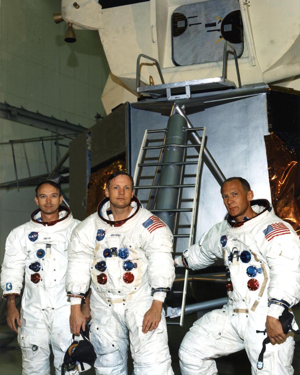 KENNEDY SPACE CENTER, FLA. - The Apollo 11 astronauts rehearsed their lunar landing mission in simulators here today. Pictured in front of a lunar module mockup in the Flight Crew Training Building area, from left, are Michael Collins, Command Module pilot; Neil A. Armstrong, commander; and Edwin E. Aldrin Jr., Lunar Module pilot.