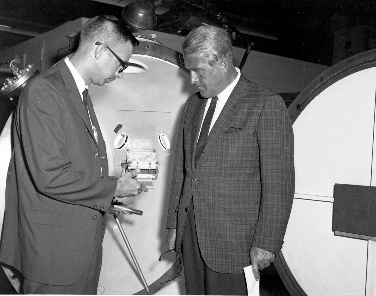 Marshall Space Flight Center’s (MSFC) director, Dr. Wernher von Braun (right), inspects a component of a laser experiment being conducted in MSFC’s Space Sciences Laboratory during a tour on August 28, 1967.