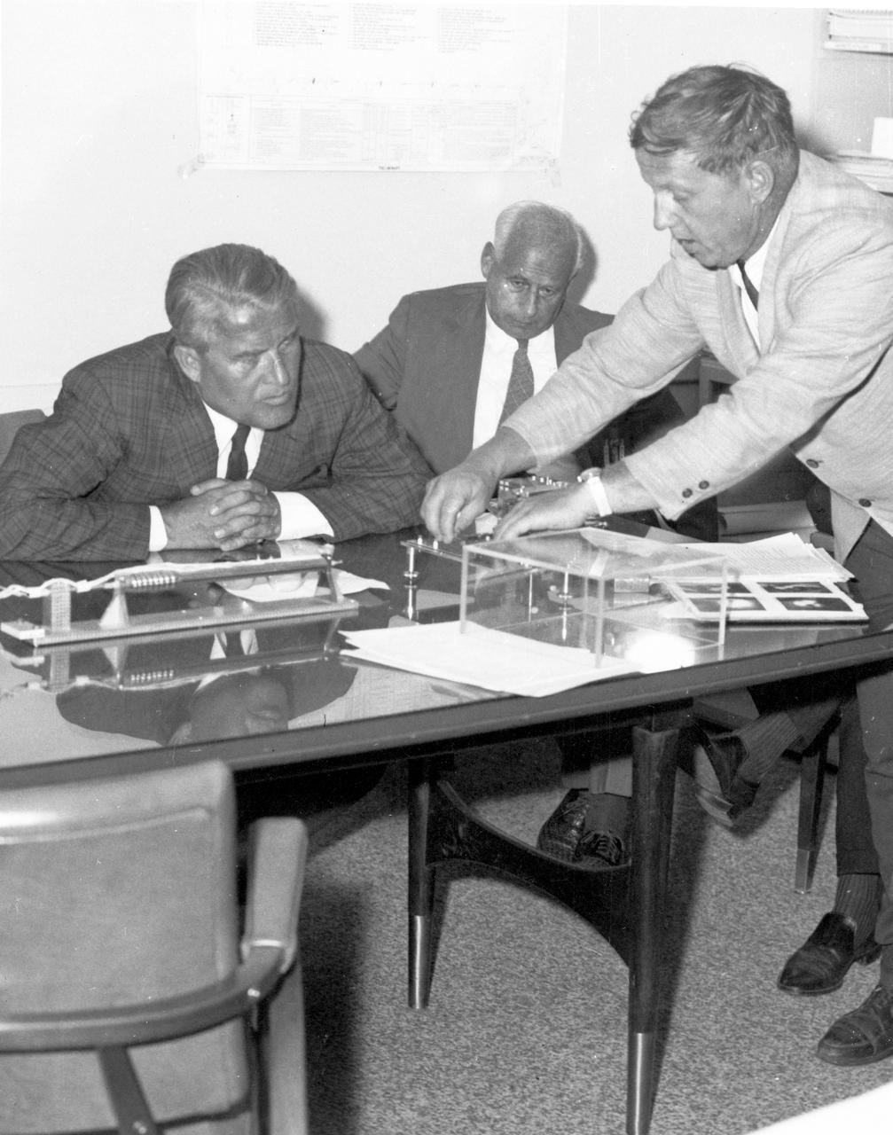 Marshall Space Flight Center’s (MSFC) director, Dr. Wernher von Braun (left), and Deputy Director, Dr. Eberhard Rees (right), get a briefing on an experiment being conducted in the MSFC Space Sciences Laboratory on August 28, 1967. 