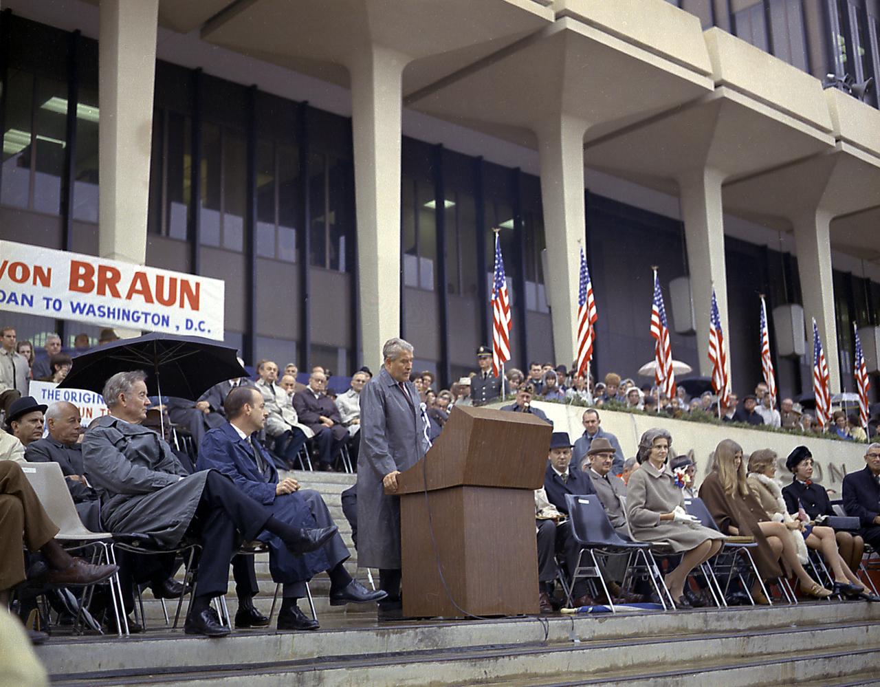 Dr. von Braun was honored with a series of farewell events and ceremonies prior to his reassignment to NASA Headquarters in Washington, D.C. Dr. von Braun speaks to the crowd in front of the Madison County Courthouse in Huntsville, Alabama. Alabama Governor Brewer and U.S. Senator Sparkman are in the foreground. 