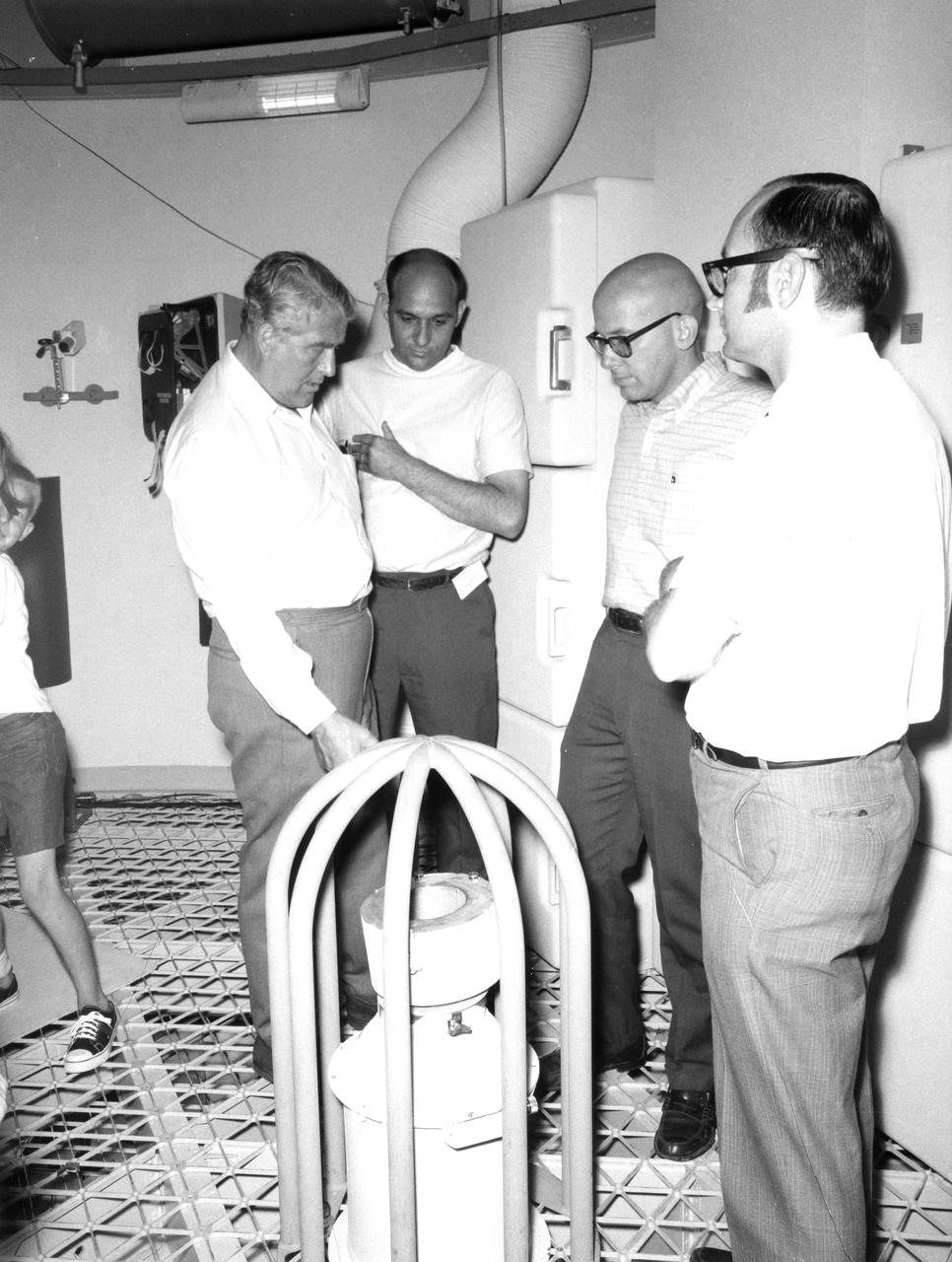 This photograph was taken after Dr. von Braun moved from his post as Director of the Marshall Space Flight Center (MSFC) to Deputy Associate Administrator for Planning at NASA Headquarters. On June 27, 1970, he visited the MSFC again during the center’s 10th anniversary to look at a mockup of the spacecraft that would later be known as Skylab. In this photo, he is examining an experiment in the mockup.  With von Braun are (left to right):  James R. Thompson, Richard T. Heckman, and Jack Stokes of the Center’s Astrionics Laboratory.
