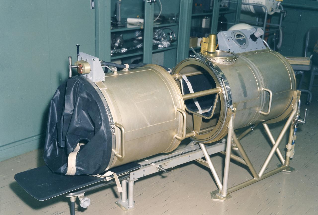 This 1970 photograph shows Skylab's In-Flight Lower Body Negative Pressure experiment facility, a medical evaluation designed to monitor changes in astronauts' cardiovascular systems during long-duration space missions. This experiment collected in-flight data for predicting the impairment of physical capacity and the degree of orthostatic intolerance to be expected upon return to Earth. Data to be collected were blood pressure, heart rate, body temperature, vectorcardiogram, lower body negative pressure, leg volume changes, and body mass. The Marshall Space Flight Center had program management responsibility for the development of Skylab hardware and experiments. 