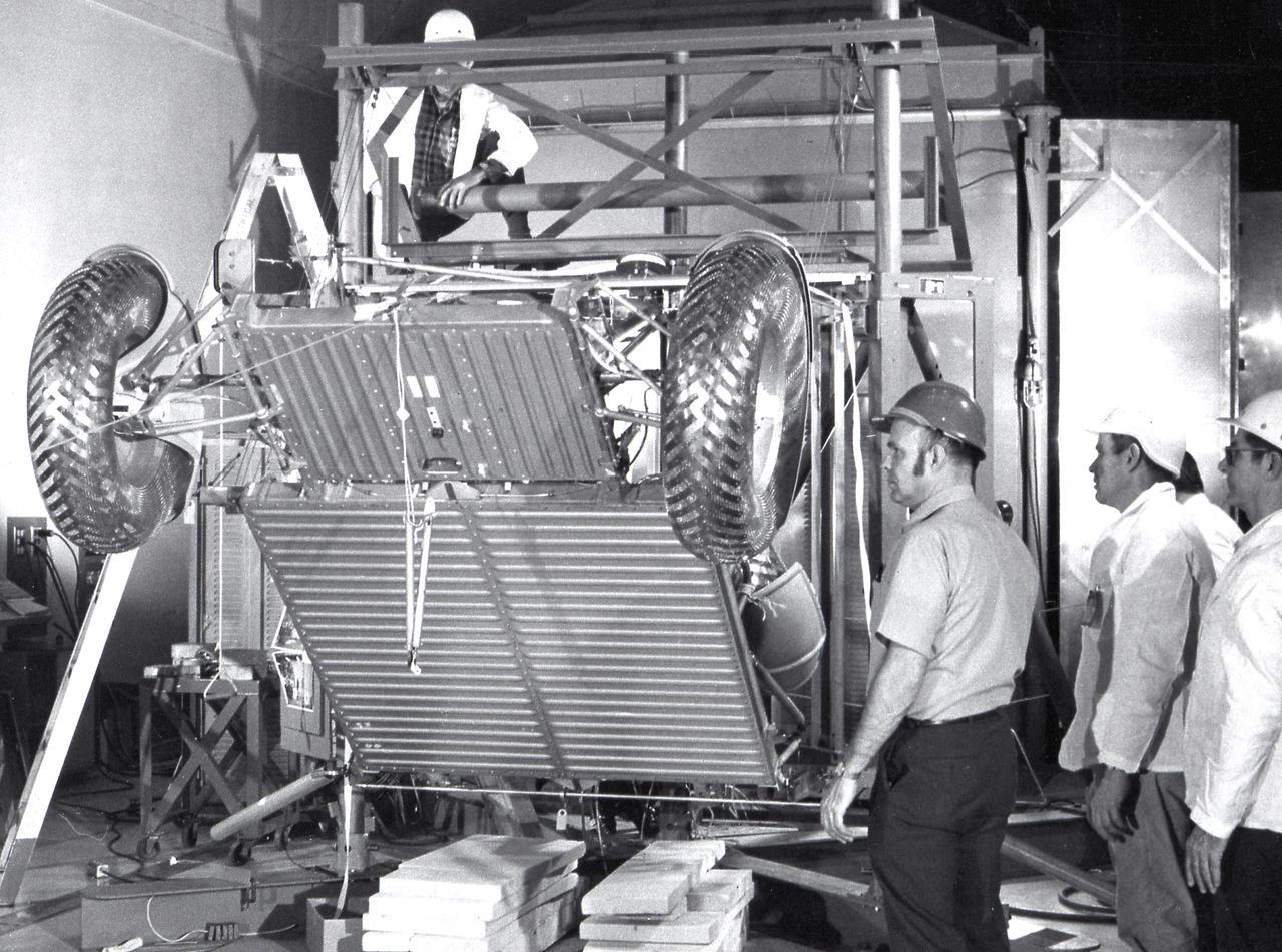 This photograph shows workmen at the Boeing plant in Kent, Washington, performing deployment tests on the Lunar Roving Vehicle (LRV). The LRV, developed under the direction of the Marshall Space Flight Center, was designed to allow Apollo astronauts a greater range of mobility on the lunar surface during the last three lunar exploration missions; Apollo 15, Apollo 16, and Apollo 17. 
