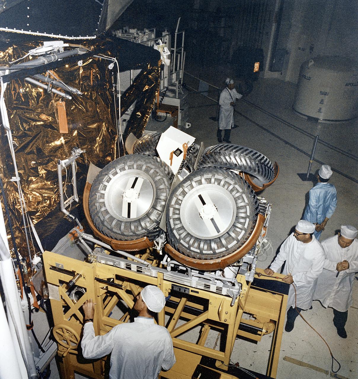 This photograph was taken during the installation of the Lunar Roving Vehicle (LRV) in the Lunar Module at the Kennedy Space Center. The LRV was built to give Apollo astronauts a greater range of mobility during the last three lunar exploration missions; Apollo 15, Apollo 16, and Apollo 17. It was designed and developed by the Marshall Space Flight Center and built by the Boeing Company.