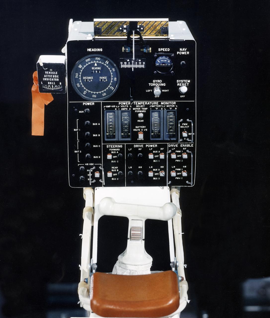 This photograph is a view of a display, control console, and hand controller for the Lunar Roving Vehicle (LRV) No. 2. The LRV was built to give Apollo astronauts a greater range of mobility during lunar exploration. It was an open-space and collapsible vehicle about 10 feet long with large mesh wheels, anterna, appendages, tool caddies, and camera. An LRV was used on each of the last three Apollo missions; Apollo 15, Apollo 16, and Apollo 17. It was built by the Boeing Company under the direction of the Marshall Space Flight Center. 