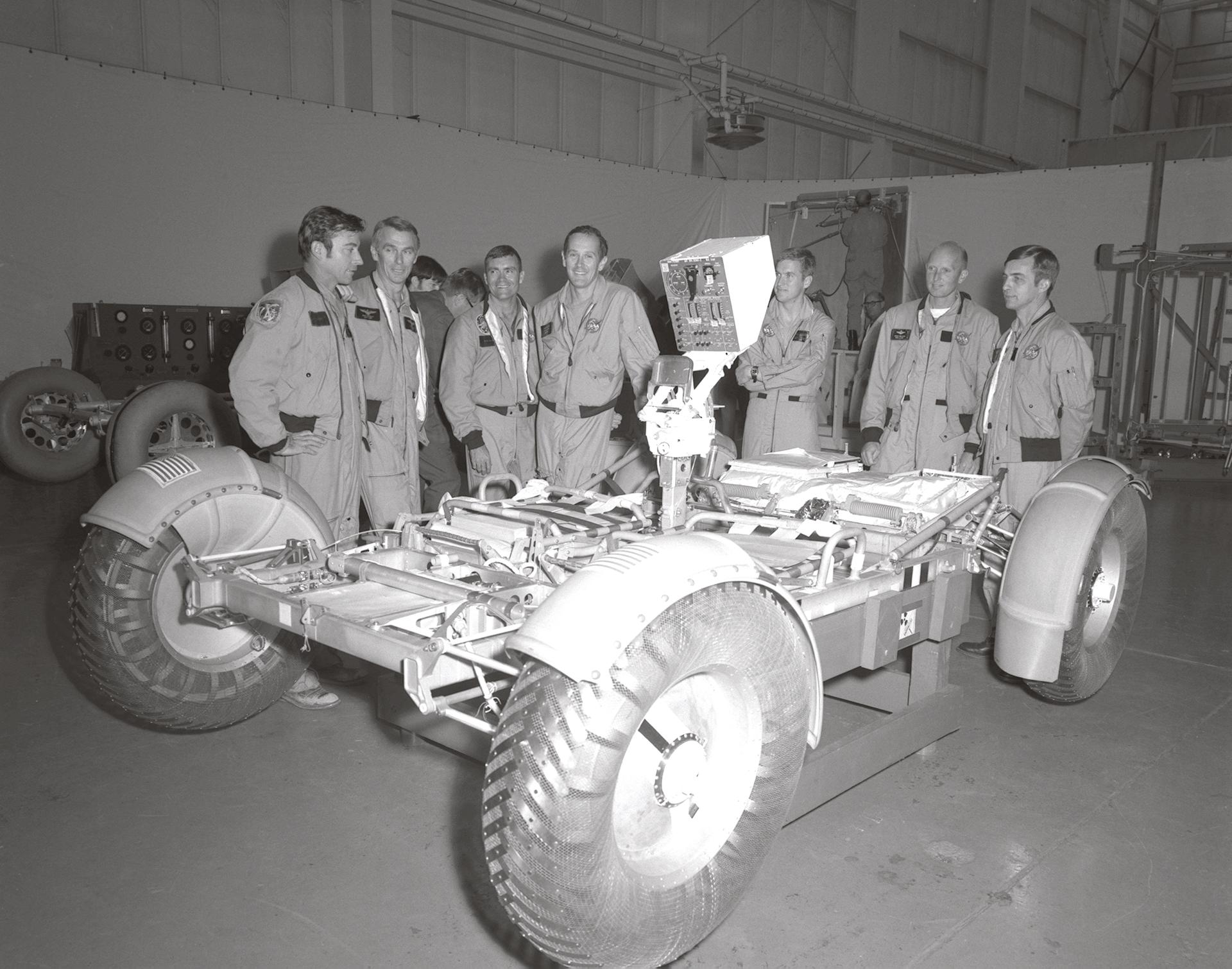 A group of men gathered around a lunar roving vehicle