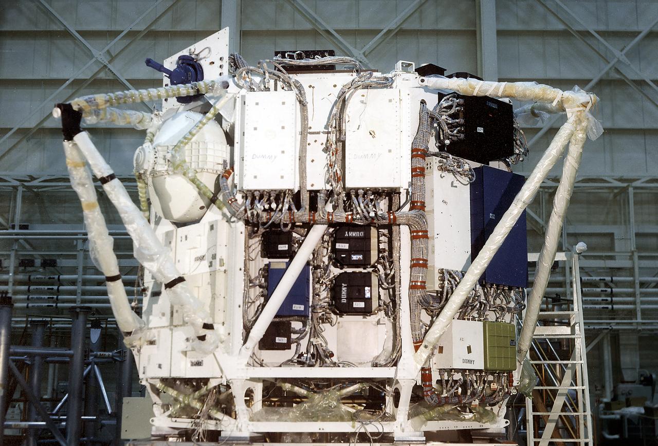 The Apollo Telescope Mount (ATM) was designed and developed by the Marshall Space Flight Center and served as the primary scientific instrument unit aboard Skylab (1973-1979). The ATM consisted of eight scientific instruments as well as a number of smaller experiments. This is a photograph of the assembly of an ATM flight unit rack. The flight unit rack was an octagonal shaped complex outer frame that housed the canister containing the solar instruments.