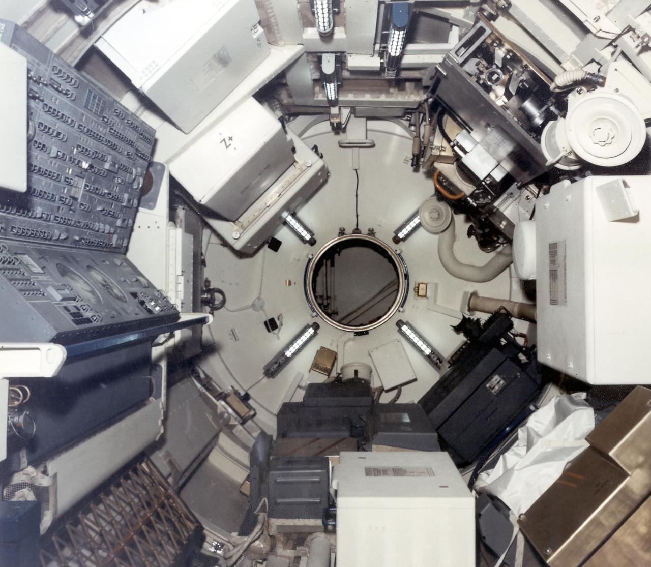 This interior photograph of Skylab's multiple docking adapter (MDA) flight article, then undergoing outfitting at the Martin Marietta Corporation's Space Center facility in Denver, Colorado, shows the forward cone area and docking turnel (center) that attached to the Apollo Command Module. Designed and manufactured by the Marshall Space Flight Center, the MDA housed the control units for the Apollo Telescope Mount (ATM), Earth Resources Experiment Package (EREP), and Zero-Gravity Materials Processing Facility and provided a docking port for the Apollo Command Module.