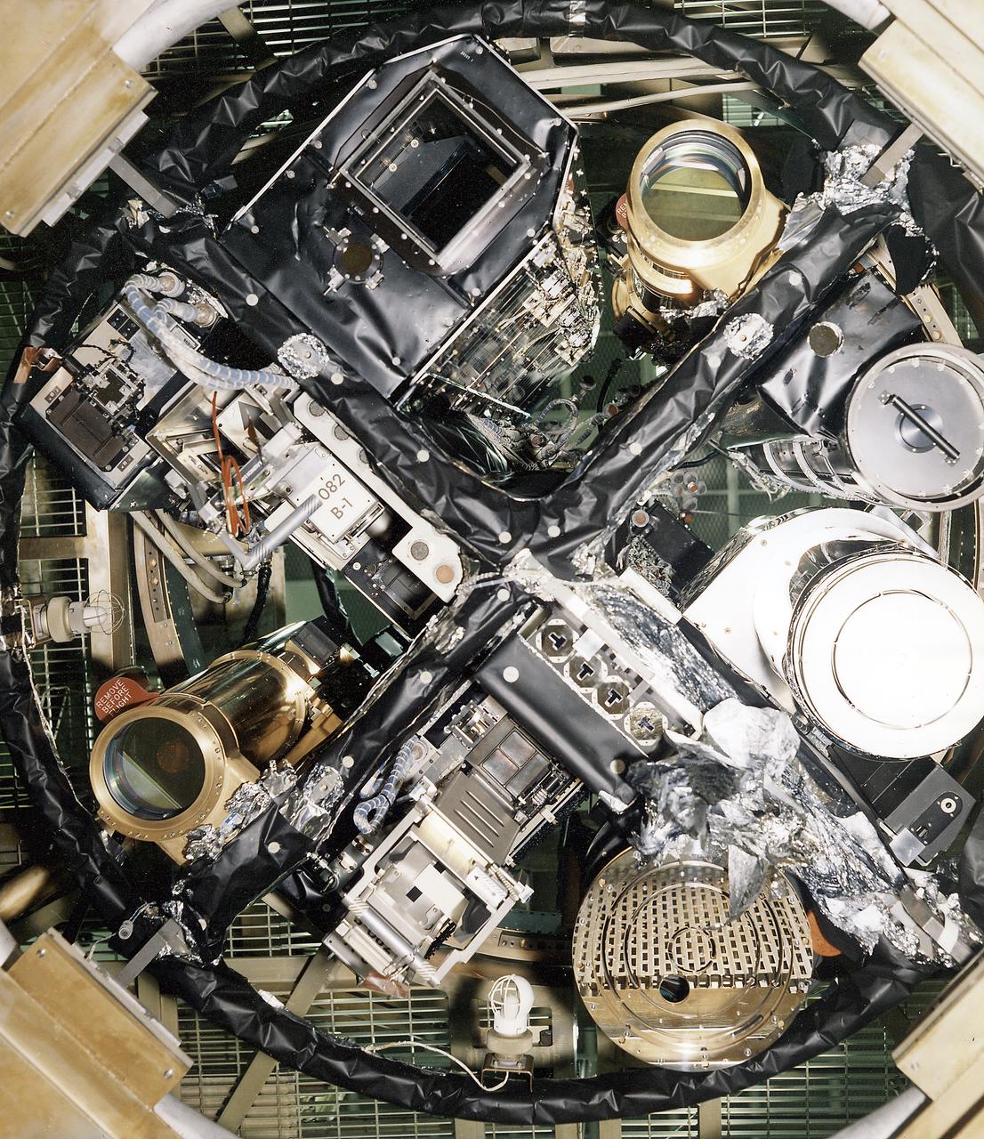 The Apollo Telescope Mount (ATM) was designed and developed by the Marshall Space Flight Center and served as the primary scientific instrument unit aboard Skylab (1973-1979). The ATM contained eight complex astronomical instruments designed to observe the Sun over a wide spectrum from visible light to x-rays. This image depicts the sun end and spar of the ATM flight unit showing individual telescopes. All solar telescopes, the fine Sun sensors, and some auxiliary systems are mounted on the spar, a cruciform lightweight perforated metal mounting panel that divides the canister lengthwise into four equal compartments. The spar assembly was nested inside a cylindrical canister that fit into a complex frame named the rack, and was protected by the solar shield.