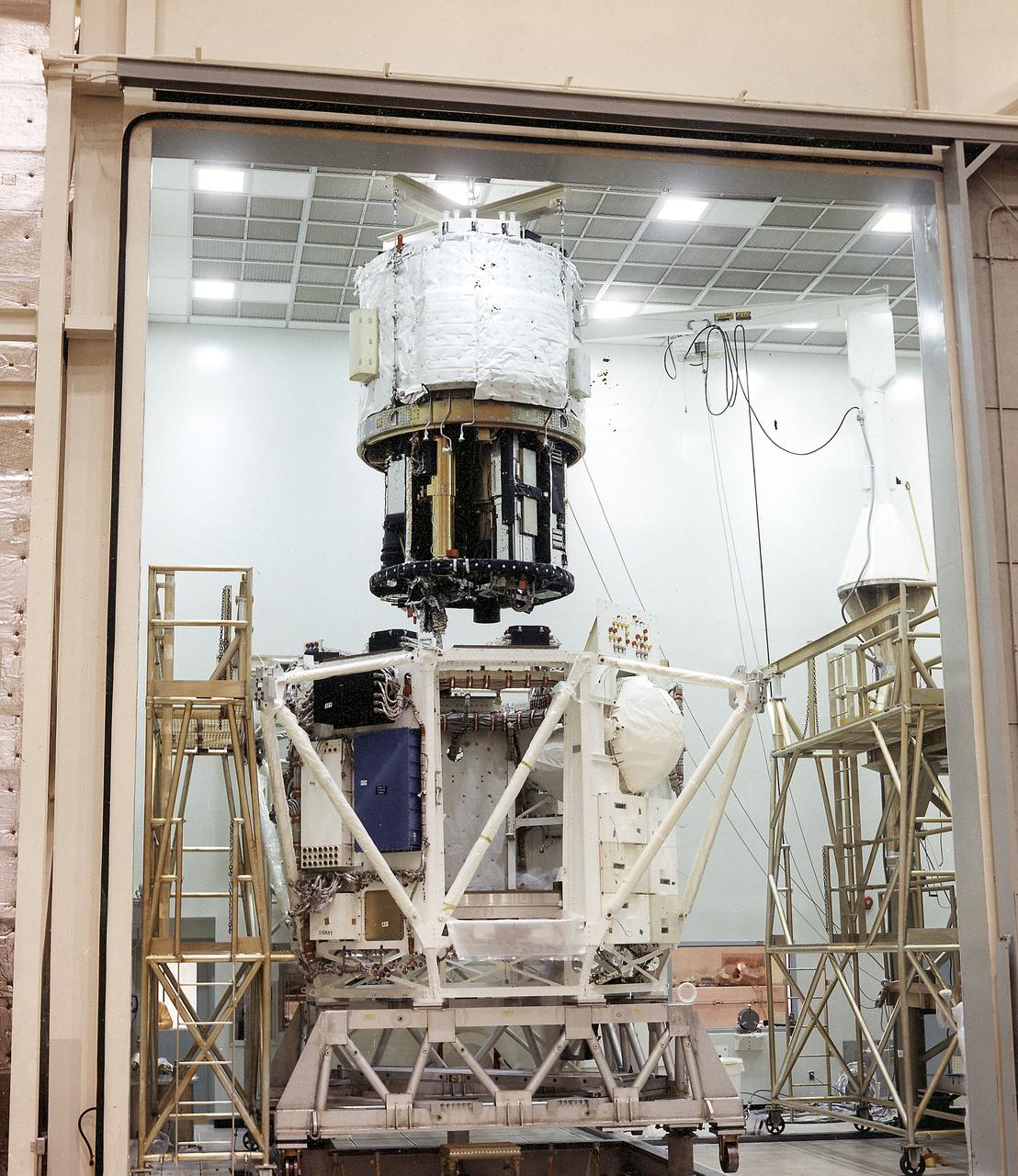 The Apollo Telescope Mount (ATM) was designed and developed by the Marshall Space Flight Center and served as the primary scientific instrument unit aboard Skylab (1973-1979). This photograph shows the spar unit, which housed major solar instruments, being lowered into the rack, the outer octagonal complex frame of the ATM flight unit. 
