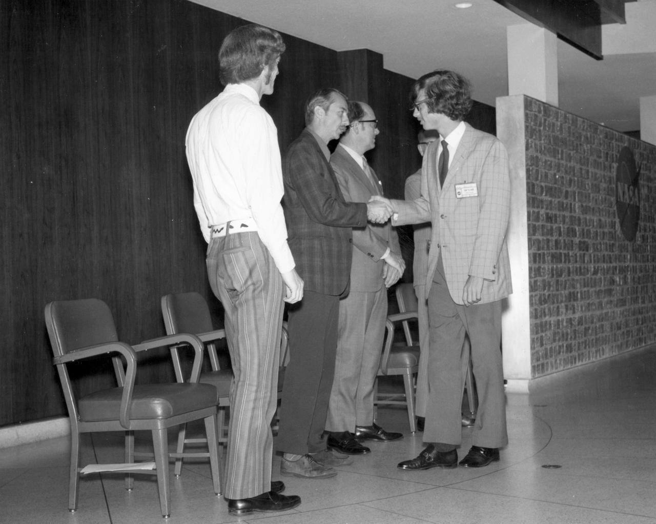 Aiea, Hawaii high school student, John C. Hamilton, is greeted by (left to right): Astronauts Russell L. Schweickart, and Owen K. Garriott; Marshall Space Flight Center (MSFC) Skylab Program Manager, Leland Belew; and MSFC Director of Administration and Technical Services, David Newby, during a tour of MSFC. Hamilton was among 25 winners of a contest in which some 3,500 high school students proposed experiments for the following year’s Skylab mission. The nationwide scientific competition was sponsored by the National Science Teachers Association and the National Aeronautics and Space Administration (NASA). The winning students, along with their parents and sponsor teachers, visited MSFC where they met with scientists and engineers, participated in design reviews for their experiments, and toured MSFC facilities. Of the 25 students, 6 did not see their experiments conducted on Skylab because the experiments were not compatible with Skylab hardware and timelines. Of the 19 remaining, 11 experiments required the manufacture of additional equipment. 