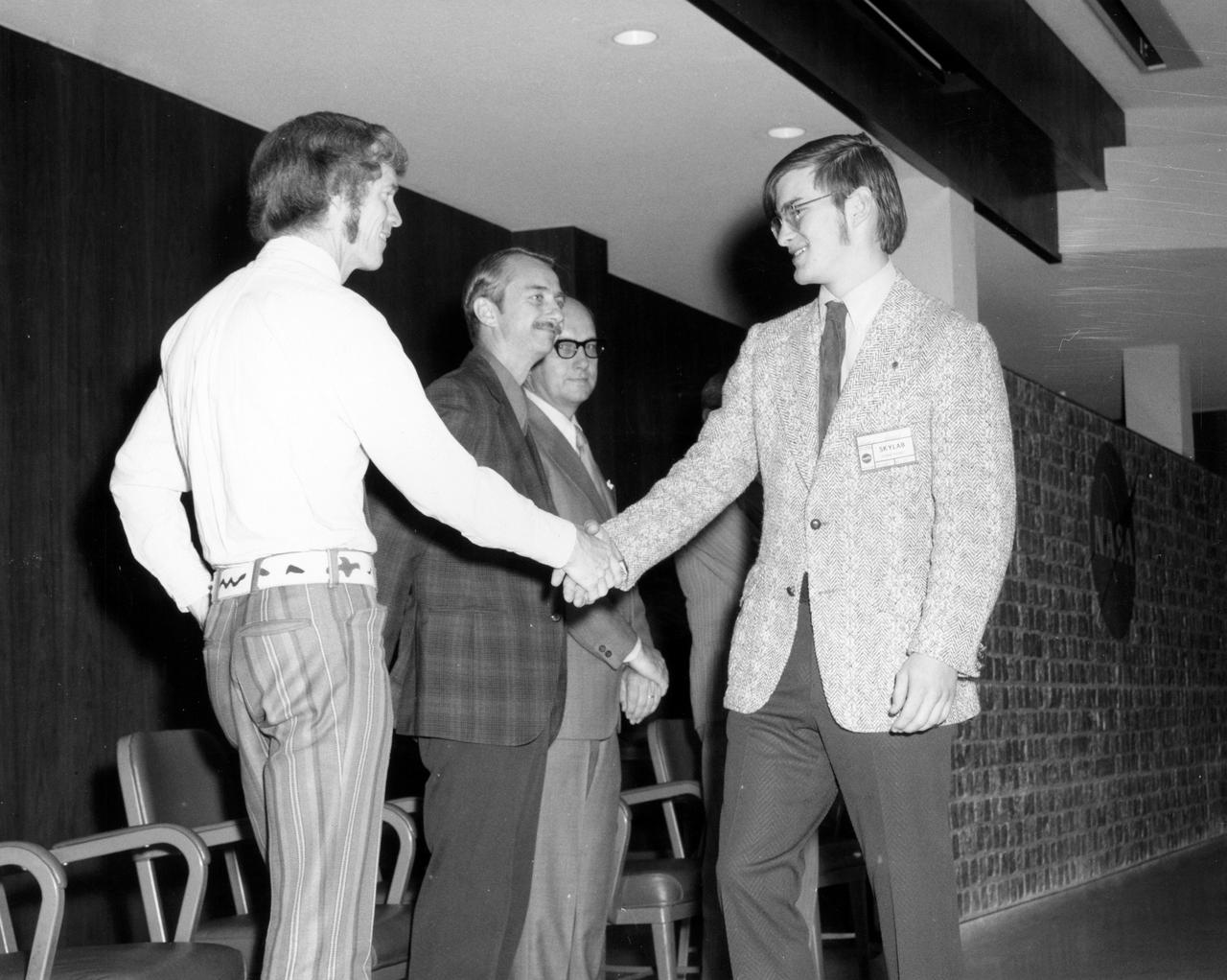 Bayport, New York high school student, James E. Healy, is greeted by (left to right): Astronauts Russell L. Schweickart, and Owen K. Garriott; Marshall Space Flight Center (MSFC) Skylab Program Manager, Leland Belew; and MSFC Director of Administration and Technical Services, David Newby, during a tour of MSFC. Healy was among 25 winners of a contest in which some 3,500 high school students proposed experiments for the following year’s Skylab mission. The nationwide scientific competition was sponsored by the National Science Teachers Association and the National Aeronautics and Space Administration (NASA). The winning students, along with their parents and sponsor teachers, visited MSFC where they met with scientists and engineers, participated in design reviews for their experiments, and toured MSFC facilities. Of the 25 students, 6 did not see their experiments conducted on Skylab because the experiments were not compatible with Skylab hardware and timelines. Of the 19 remaining, 11 experiments required the manufacture of additional equipment. 