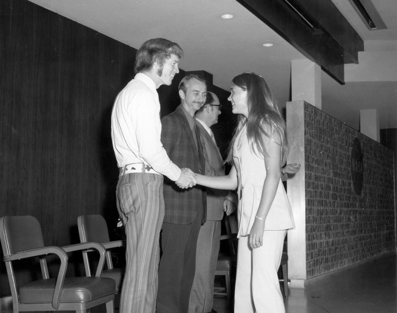 Houston, Texas high school student, Kathy L. Jackson, is greeted by astronauts Russell L. Schweickart (left) and Owen K. Garriott (center), and Marshall Space Flight Center (MSFC) Skylab Program Manager, Leland Belew during a tour of the Marshall Space Flight Center (MSFC). Jackson was among 25 winners of a contest in which some 3,500 high school students proposed experiments for the following year’s Skylab mission. The nationwide scientific competition was sponsored by the National Science Teachers Association and the National Aeronautics and Space Administration (NASA). The winning students, along with their parents and sponsor teachers, visited MSFC where they met with scientists and engineers, participated in design reviews for their experiments, and toured MSFC facilities. Of the 25 students, 6 did not see their experiments conducted on Skylab because the experiments were not compatible with Skylab hardware and timelines. Of the 19 remaining, 11 experiments required the manufacture of additional equipment. 
