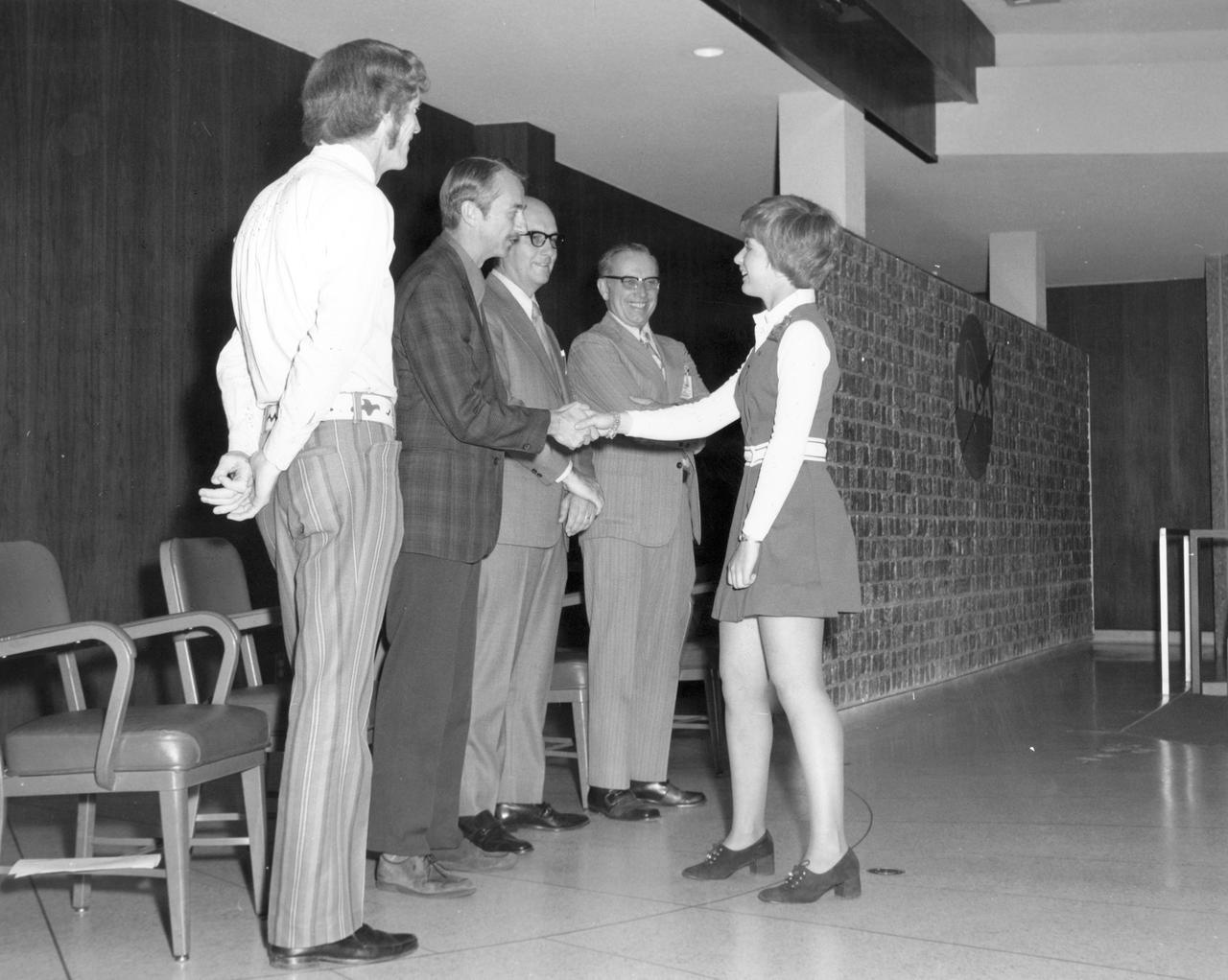 Littleton, Colorado high school student, Cheryl A. Peltz, is greeted by (left to right): Astronauts Russell L. Schweickart, and Owen K. Garriott; Marshall Space Flight Center (MSFC) Skylab Program Manager, Leland Belew; and MSFC Director of Administration and Technical Services, David Newby, during a tour of MSFC.  Peltz was among 25 winners of a contest in which some 3,500 high school students proposed experiments for the following year’s Skylab mission. The nationwide scientific competition was sponsored by the National Science Teachers Association and the National Aeronautics and Space Administration (NASA). The winning students, along with their parents and sponsor teachers, visited MSFC where they met with scientists and engineers, participated in design reviews for their experiments, and toured MSFC facilities. Of the 25 students, 6 did not see their experiments conducted on Skylab because the experiments were not compatible with Skylab hardware and timelines. Of the 19 remaining, 11 experiments required the manufacture of additional equipment. 