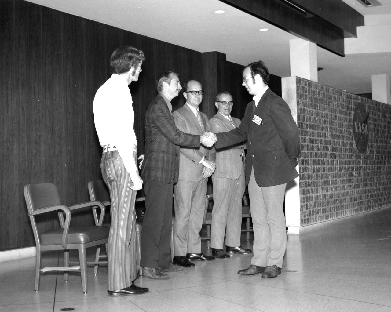 Baton Rouge, Louisiana high school student, Joe W. Reihs, is greeted by (left to right): Astronauts Russell L. Schweickart, and Owen K. Garriott; Marshall Space Flight Center (MSFC) Skylab Program Manager, Leland Belew; and MSFC Director of Administration and Technical Services, David Newby, during a tour of MSFC. Reihs was among 25 winners of a contest in which some 3,500 high school students proposed experiments for the following year’s Skylab mission. The nationwide scientific competition was sponsored by the National Science Teachers Association and the National Aeronautics and Space Administration (NASA). The winning students, along with their parents and sponsor teachers, visited MSFC where they met with scientists and engineers, participated in design reviews for their experiments, and toured MSFC facilities. Of the 25 students, 6 did not see their experiments conducted on Skylab because the experiments were not compatible with Skylab hardware and timelines. Of the 19 remaining, 11 experiments required the manufacture of additional equipment. 