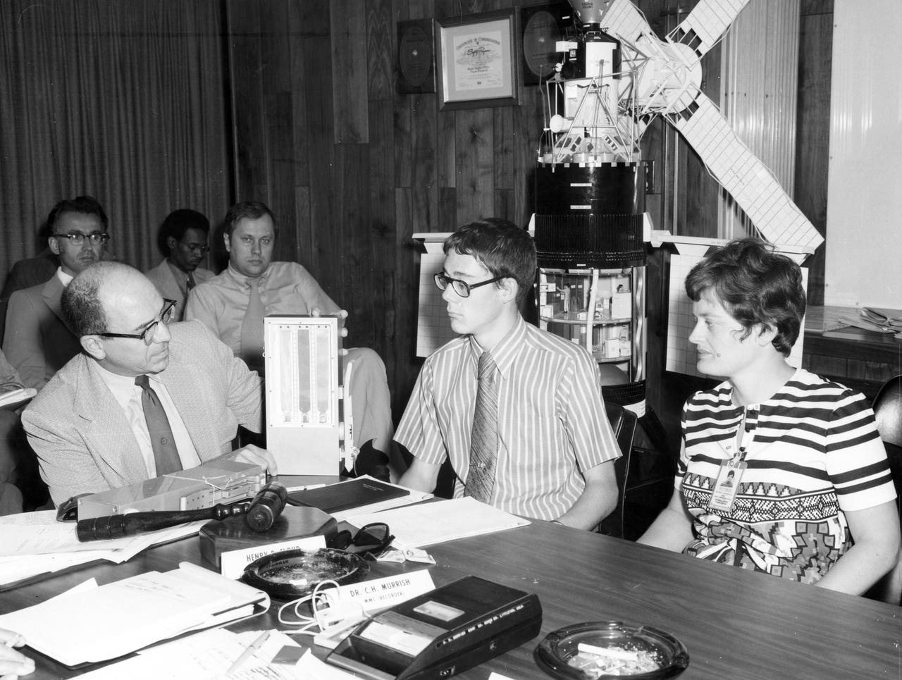 St. Paul Minnesota high school student, Roger Johnston (center), Gene Vacca (left) of NASA Headquarters, and Ann Whitaker of the Marshall Space Flight Center (MSFC) discuss the equipment to be used for the student’s experiment, “Capillary Action Studies in a State of Free Fall”, to be performed aboard the Skylab the following year. Johnston was among 25 winners of a contest in which some 3,500 high school students proposed experiments for the following year’s Skylab mission. The nationwide scientific competition was sponsored by the National Science Teachers Association and the National Aeronautics and Space Administration (NASA). The winning students, along with their parents and sponsor teachers, visited MSFC two months earlier where they met with scientists and engineers, participated in design reviews for their experiments, and toured MSFC facilities. Of the 25 students, 6 did not see their experiments conducted on Skylab because the experiments were not compatible with Skylab hardware and timelines. Of the 19 remaining, 11 experiments required the manufacture of additional equipment. The equipment for the experiments was manufactured at MSFC.
