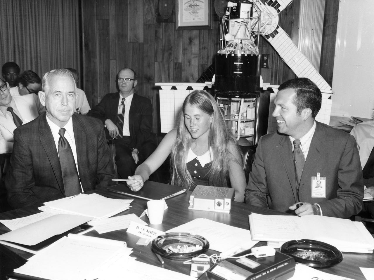 Kathy Jackson, high school student from Houston, Texas, discusses her experiment with Dr. Robert Allen (left) and her scintific advisor Arthur White, both of the Marshall Space Flight Center (MSFC).  Miss Jackson’s experiment tested the motor sensory performance of an astronaut at various times during the Skylab flight to detect any degredation in his eye-hand coordination. She was one of the 25 winners of a contest in which some 3,500 high school students proposed experiments for the following year’s Skylab mission. Of the 25 students, 6 did not see their experiments conducted on Skylab because the experiments were not compatible with Skylab hardware and timelines. Of the 19 remaining, 11 experiments required the manufacture of equipment.
