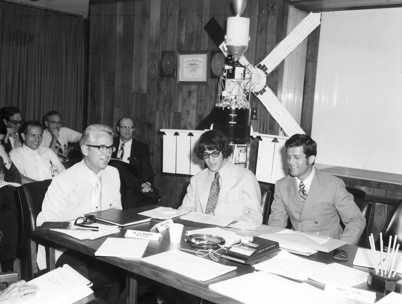 Robert L. Staehle (center), high school student from Harley School, Rochester New York, talks with Steven Hall (advisor to Staehle) and Henry Floyd, both of the Marshall Space Flight Center (MSFC) about his experiment “Behavior of Bacteria and Bacterial Spores in the Skylab Space Environment”. He was one of the 25 winners of a contest in which some 3,500 high school students proposed experiments for the following year’s Skylab mission. Of the 25 students, 6 did not see their experiments conducted on Skylab because the experiments were not compatible with Skylab hardware and timelines. Of the 19 remaining, 11 experiments required the manufacture of equipment.
