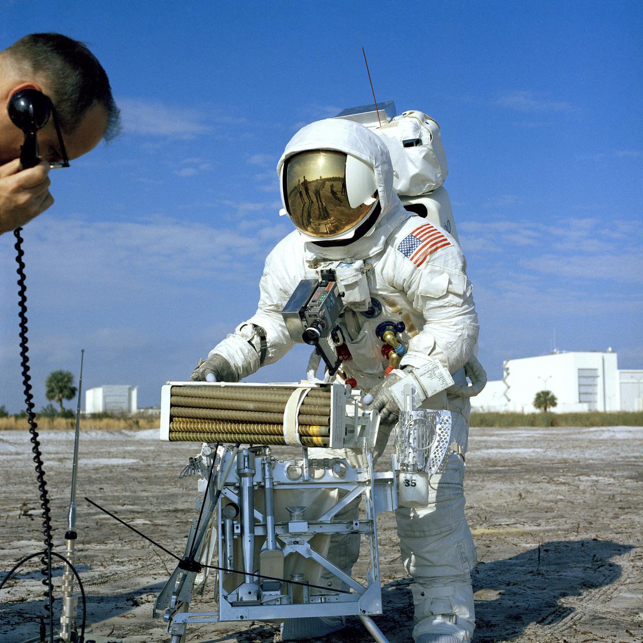 CAPE CANAVERAL, Fla. - Fred W. Haise Jr., Apollo 13 lunar module pilot, participated in a walk-through of the extravehicular activity timeline near the Flight Crew Training Building here today. In the foreground is the lunar surface tool carrier topped by auger-like pipes to be used with a motorized device to obtain soil sample cores in the moon's rugged Fra Mauro region. Apollo 13 is scheduled for launch from Complex 39A no earlier than April 11. The other crew members are James A. Lovell Jr., commander, and Thomas K. Mattingly II, command module pilot. Photo credit: NASA