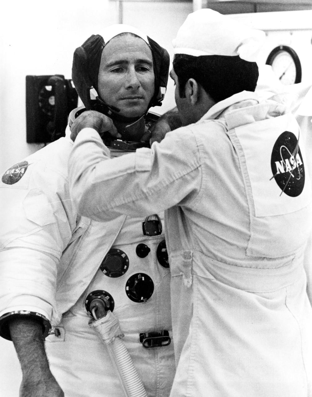 KENNEDY SPACE CENTER, FLA. -- A technician adjusts the spacesuit of Apollo 15 Lunar Module Pilot James B. Irwin prior to his launch to the Moon today with astronauts David R. Scott and Alfred N. Worden. The National Aeronautics and Space Administration directs the Apollo program.
