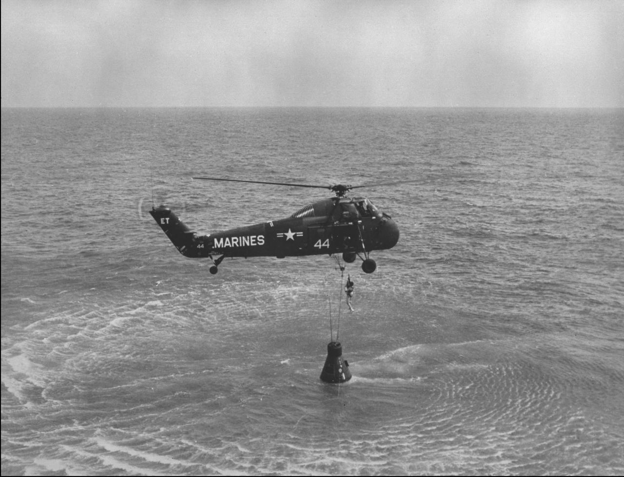 KENNEDY SPACE CENTER, FLA. -- NASA Astronaut Alan B. Shepard Jr. is hoisted up in a body harness by a U.S. Marine helicopter recovery team following the first Project Mercury suborbital space flight.  Astronaut Shepard, along with his spacecraft, was then taken to the U.S. Navy Carrier Chaplain.