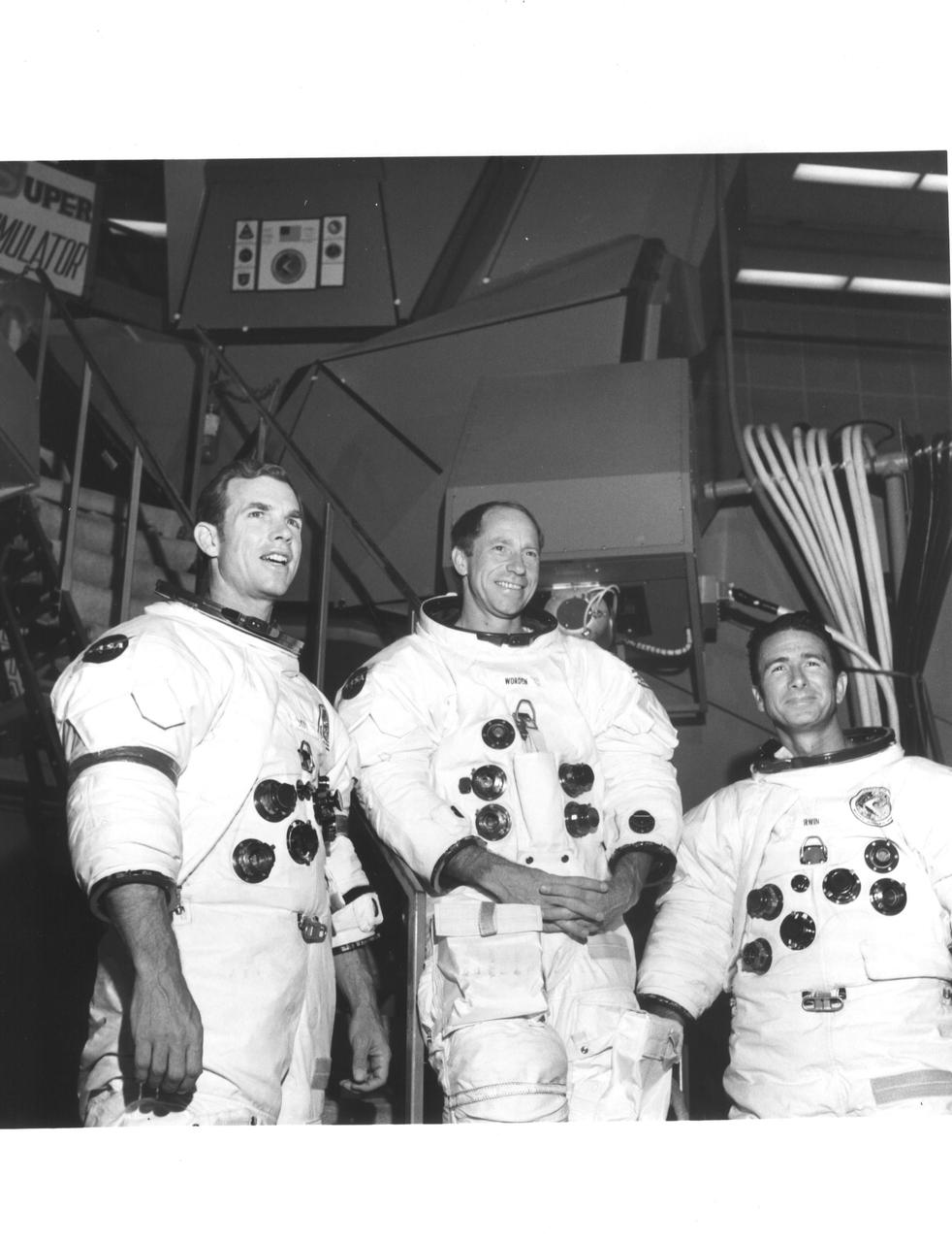 KENNEDY SPACE CENTER, FLA. -- The Apollo 15 astronauts pause in front of a mission simulator during a training exercise at the Kennedy Space Center. The trio will be launched to the Moon no earlier than July 26, 1971. They are, left to right, David R. Scott, commander; Alfred N. Worden, command module pilot; and James B. Irwin, lunar module pilot.