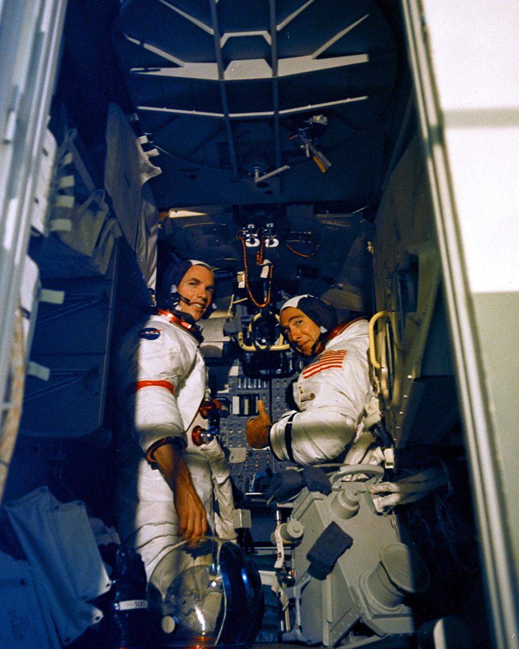 KENNEDY SPACE CENTER, FLA. - Apollo 15 Commander David R. Scott, left, and James B. Irwin practice an aspect of their upcoming lunar landing mission in the Lunar Module Simulator located at the Kennedy Space Center. They will be launched to the Moon, along with Command Module Pilot Alfred M. Worden, no earlier than July 26, 1971.