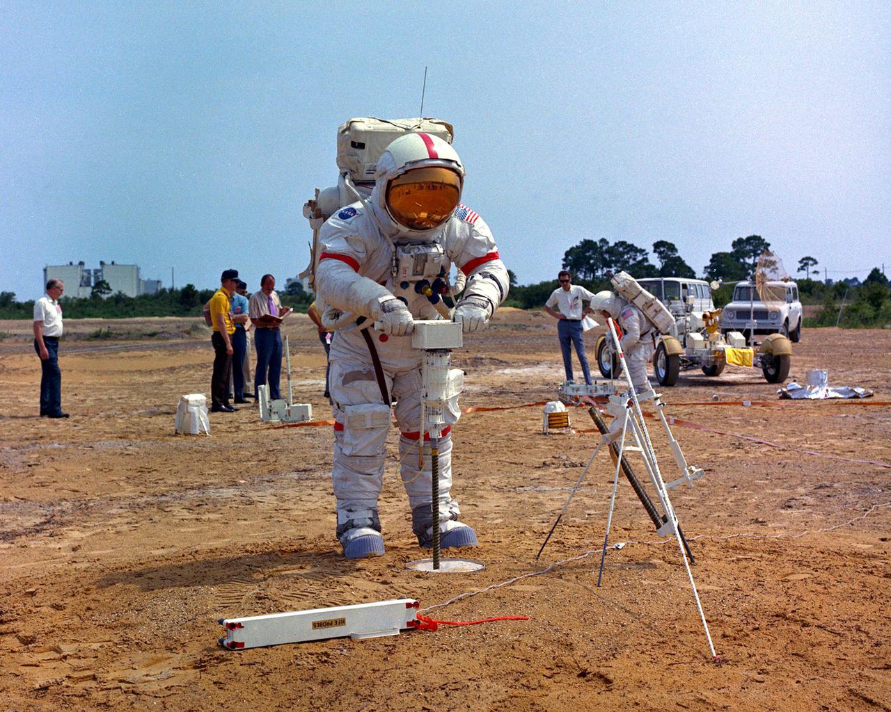KENNEDY SPACE CENTER, FLA. - Apollo 15 Commander David R. Scott operates the battery-powered Lunar Surface Drill during a training exercise at a man-made replica of the Moon's Hadley-Apennine region at the Kennedy Space Center. During his upcoming mission, scheduled to begin no earlier than July 26, 1971, Scott will drill to a depth of about 10 feet to obtain lunar surface core samples and conduct the Heat Flow Experiment. This experiment is designed to measure the rate of heat loss from the interior of the Moon. Lunar Module Pilot James B. Irwin will accompany Scott on the surface while Astronaut Alfred M. Worden will pilot the Command Module while in lunar orbit.