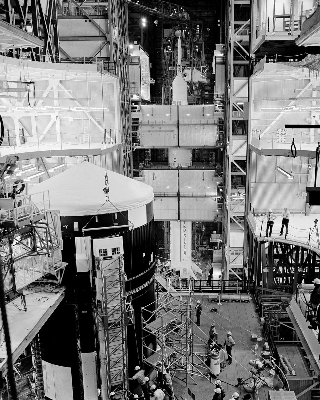 CAPE KENNEDY, Fla. -- At the Kennedy Space Center in Florida, one of Skylab 1's solar cell arrays is installed on the orbital space station in High Bay 2 of the Vehicle Assembly Building. Skylab 2 launch vehicle is in high bay 1, visible in the background. Each of the two solar cell arrays on the space station that will be deployed in orbit is designed to provide 10,500 watts of power. All power needed to operate the station and the Apollo Telescope mount will be taken from the arrays. Each array will have almost 1,177 square feet of surface area to turn sunlight into electrical power. Skylab 1 is schedule for launch April 30, 1973 and Skylab 2, carrying the astronauts Charles Conrad Jr., Dr. Joseph P. Kerwin and Paul J. Weitz to dock with the space station and enter it to live and work for 28 days, will be launched a day later. Photo Credit: NASA