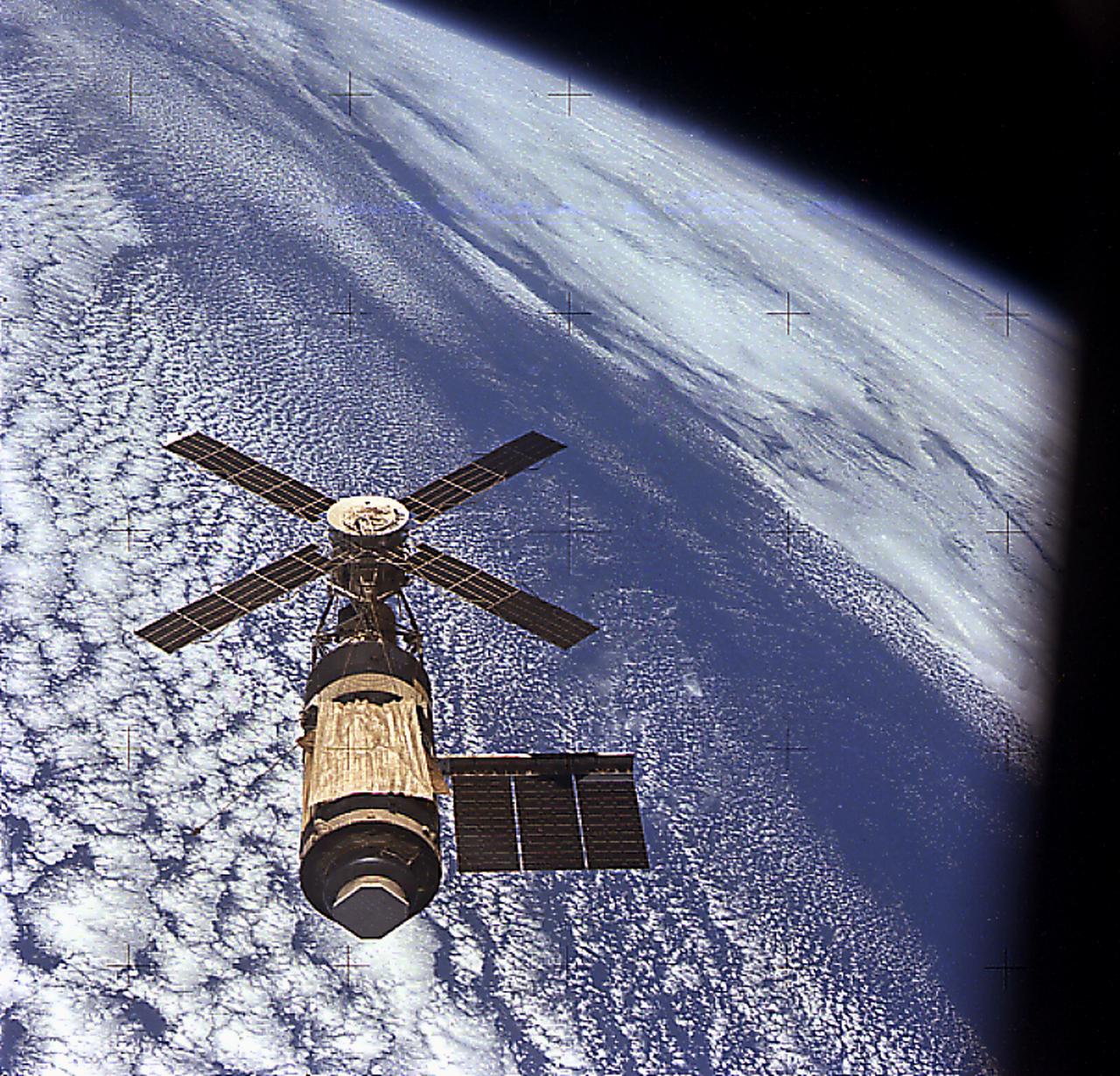 The idea that ultimately became Skylab first surfaced in 1962 as a proposal to convert a spent Saturn upper stage (Saturn V S-II stage) into an orbital workshop. In 1968, the Marshall Space Flight Center proposed an alternative to the wet workshop concept of refurbishing a space station in orbit. Instead, a fully equipped dry workshop could be launched as a complete unit ready for occupancy. Skylab became the free world's first space station. Launched in May 1973, the Skylab space station was occupied in succession by three teams of three crewmembers. These crews spent 28, 59, and 84 days respectively, orbiting the Earth and performing nearly 300 experiments. This view of Skylab in orbit was taken by the Skylab 4 (the last Skylab mission) crew.