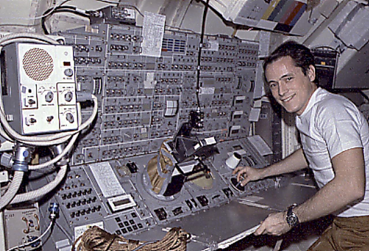 This Skylab-4 mission onboard photograph shows Astronaut Ed Gibson at the complex control and display console for the Apollo Telescope Mount solar telescopes located in the Skylab Multiple Docking Adapter. Astronauts watched the Sun, and photographed and recorded the solar activities, such as the birth of a solar flare.