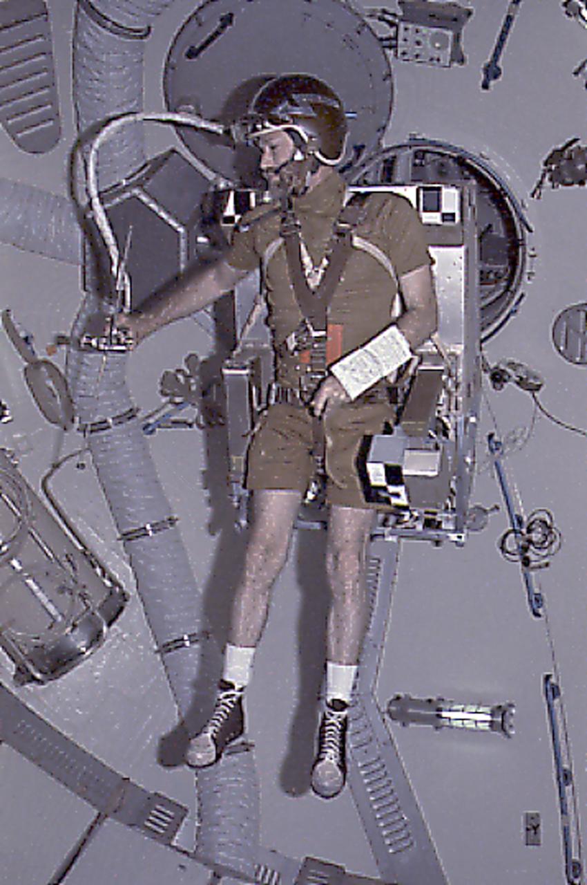 This Skylab-4 onboard photograph depicts Astronaut Gerald Carr testing Astronaut Maneuvering Equipment (M509) by flying it around under weightless conditions in the Orbital Workshop. The M509 experiment was an operational study to evaluate and conduct an in-orbit verification of the utility of various maneuvering techniques to assist astronauts in performing tasks that were representative of future extravehicular activity requirements.