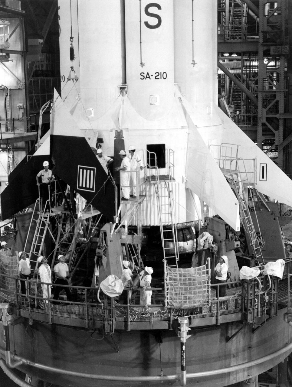 KENNEDY SPACE CENTER, FLA. -- The replacement of fins on the Apollo Soyuz Test Project S1B launch vehicle continued at KSC today. The decision to replace all of the fins was made when small hairline stress corrosion cracks were discovered in holddown fittings. Replacement of the fins is not expected to delay move of the launch vehicle to the launch pad on March 24. ASTP, the joint U.S._USSR space mission is scheduled for mid-July.