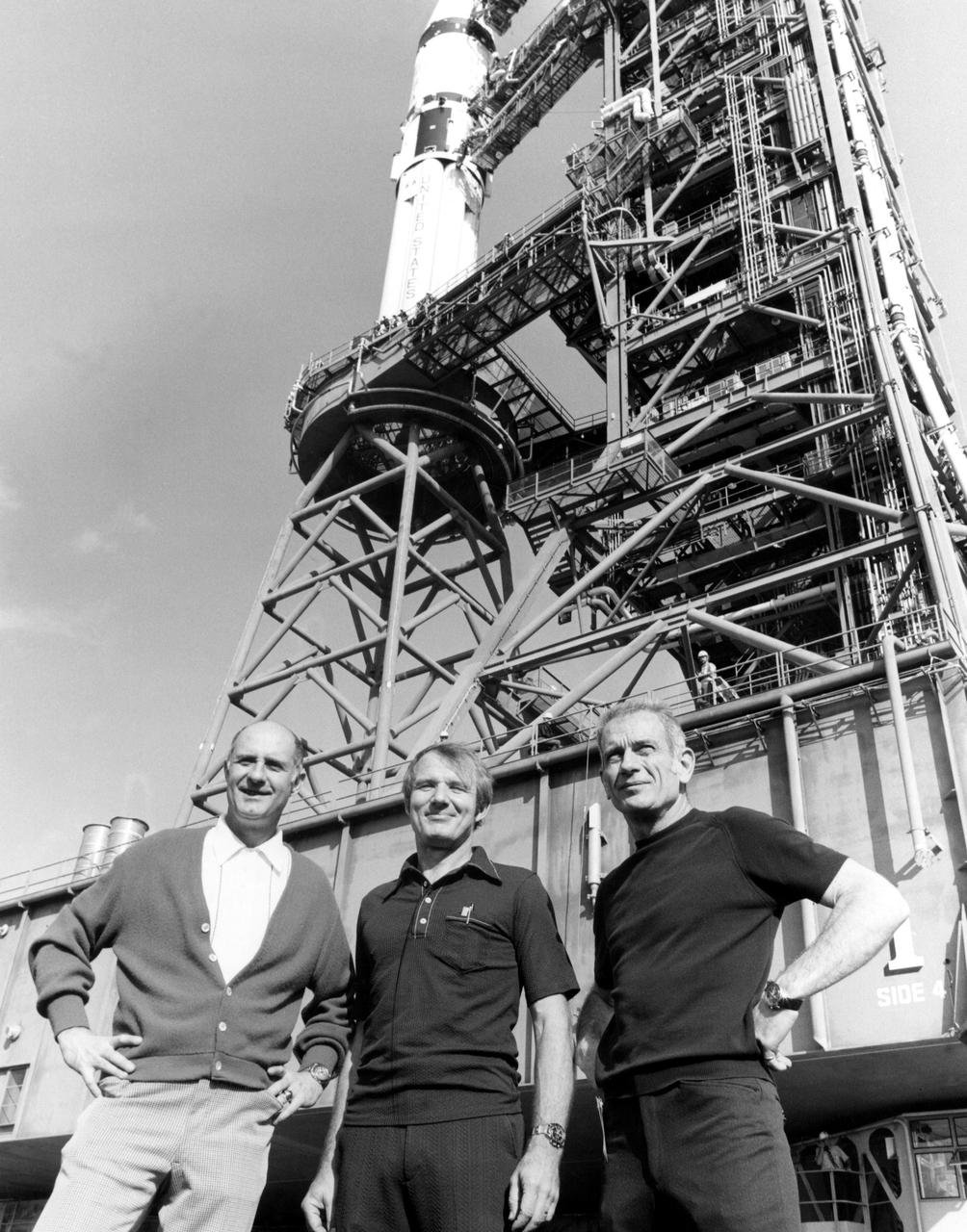 KENNEDY SPACE CENTER, FLA. --  U.S. astronauts Thomas Stafford (left), Vance Brand (center) and Donald Slayton pose in front of their Apollo Soyuz Test Project space vehicle during rollout ceremonies at KSC.  The 224-foot-tall Saturn IB launch vehicle began its five-mile journey from the Vehicle Assembly Building to Complex 39's Pad at 8 a.m.  The ASTP launch is scheduled for 3:50 p.m. EDT on July 15.  During the mission the U.S. Apollo spacecraft will rendezvous and dock with the Soviet Soyuz spacecraft.  It will be history's first international manned space flight.