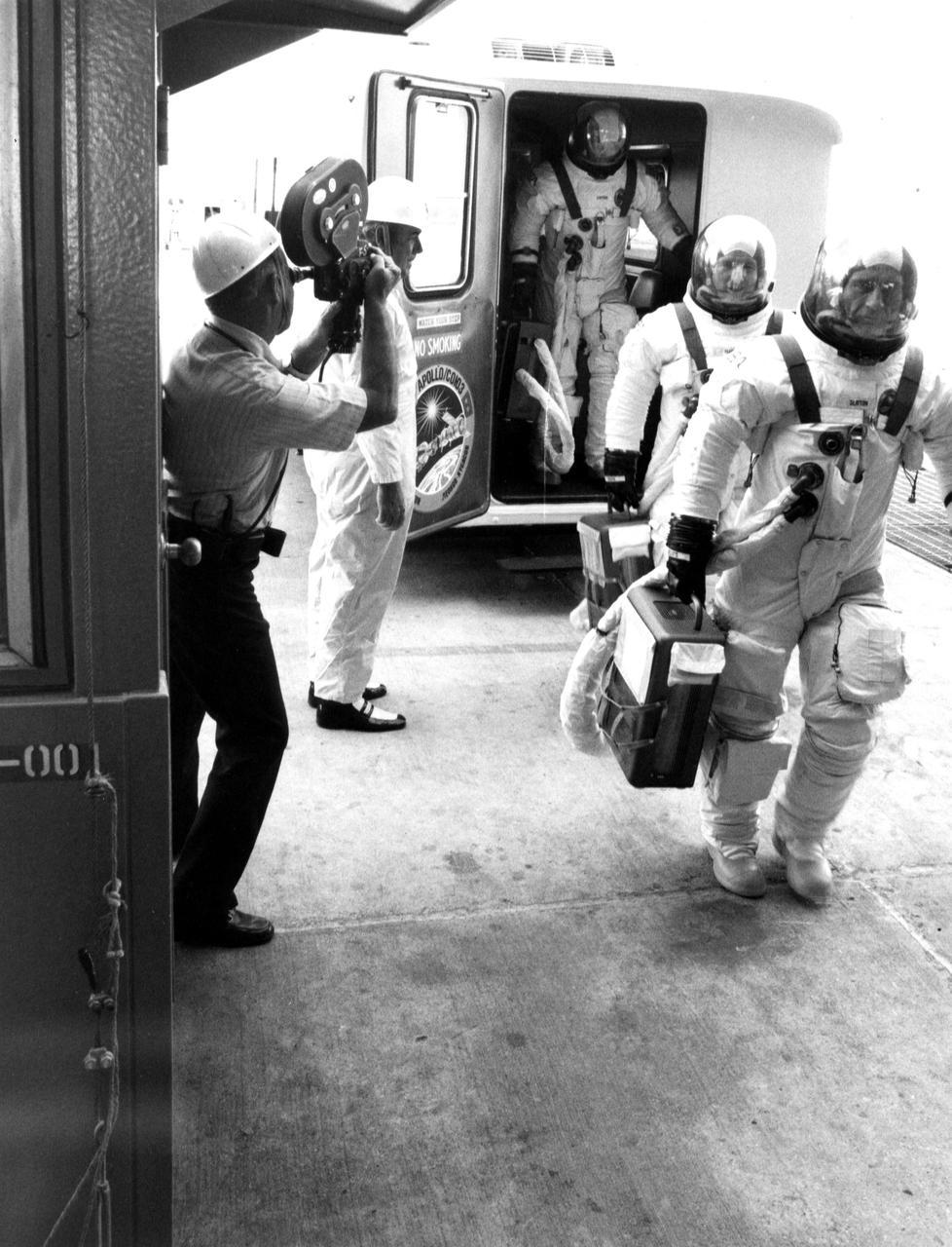 KENNEDY SPACE CENTER, FLA. -- ASTP asstronauts Donald slayton, Vance Brand and Thomas Stafford leave the transfer van at Complex 39's Pad B and enter the pad elevator during the Countdown Demonstration Test. The test, a step-by-step dress rehearsal for the July 15 launch, simulates the actual countdown but without the propellants in the Saturn IB launch vehicle's fuel tanks. The fueled portion of the test was conducted yesterday.