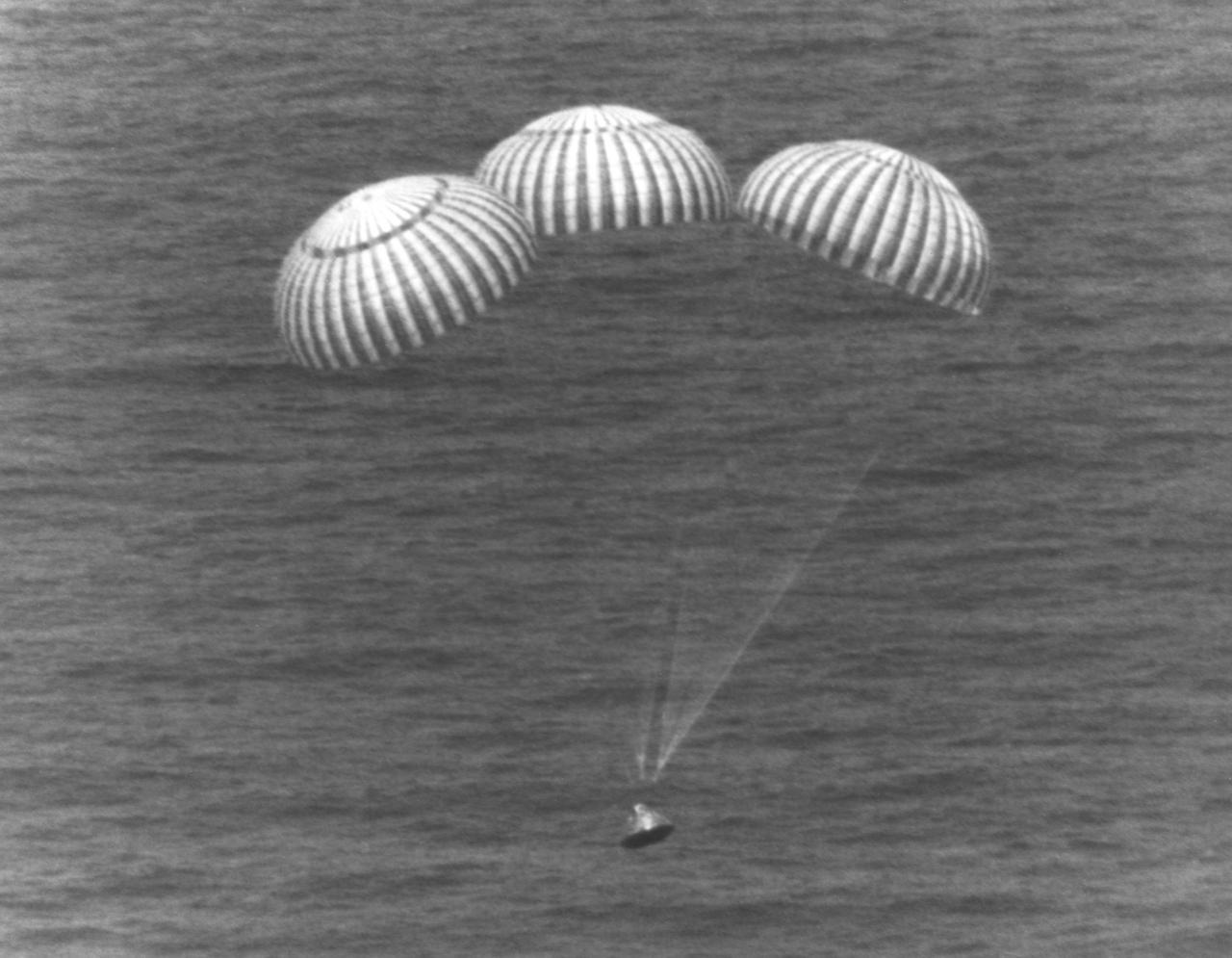 KENNEDY SPACE CENTER, FLA. --  The three main parachutes lower the ASTP Apollo Command Module into the Pacific Ocean west of Hawaii.  The splashdown at 5:18 p.m. ended the nine-day mission for ASTP astronauts Thomas Stafford, Vance Brand and Donald Slayton.  The Apollo was picked up by the USS New Orleans after which the crewmen participated in ceremonies on the ship's deck.