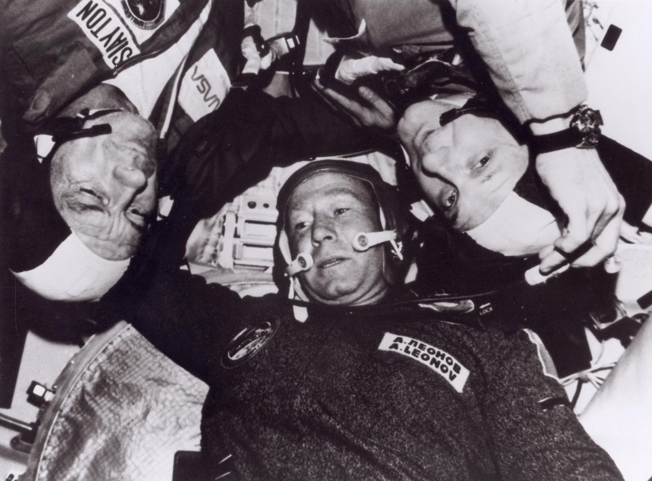 The final launch of a Saturn rocket came on July 15, 1975 as part of the Apollo-Soyuz Test Project. Earlier that day, a Russian Soyuz spacecraft lifted off its launch pad at a Soviet launch site carrying three cosmonauts. Seven and one-half hours later, the U.S. Apollo spacecraft was launched with its crew of American astronauts. Rendezvous and docking of the two ships were accomplished on July 17. The two ships remained docked for two days, conducting joint experiments and exchanging national mementos. In this photograph, astronauts Donald Slayton and Thomas Stafford chat with cosmonaut Alexei Leonov during their visit to the Soyuz Orbital Module.