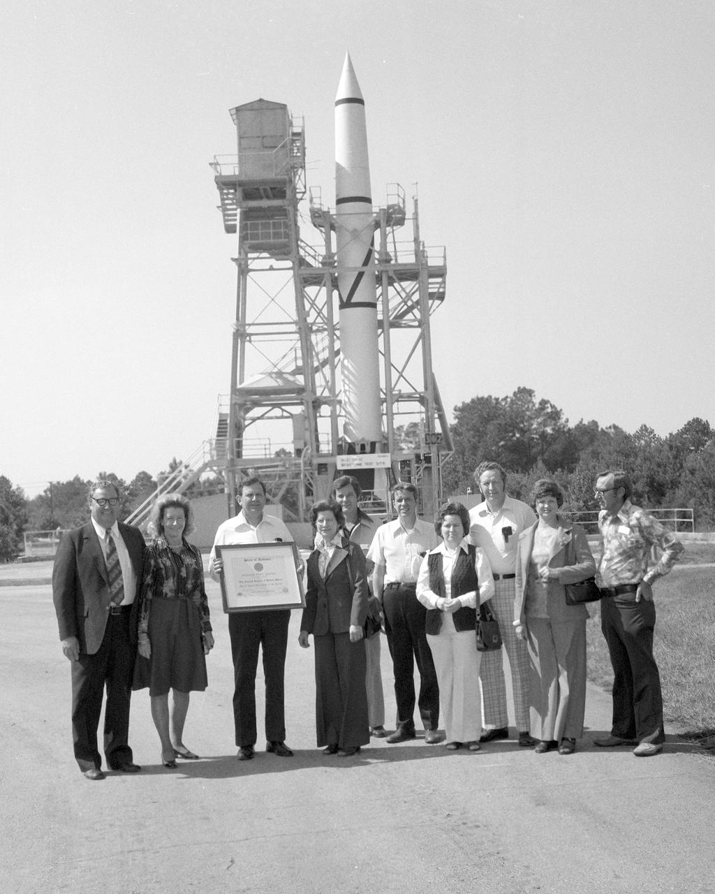 On October 02, 1976, Marshall Space Flight Center’s (MSFC) Redstone test stand was received into the National Registry of Historical Places. Photographed in front of the Redstone test stand along with their wives are (left to right), Madison County Commission Chairman James Record, Dr. William R. Lucas, MSFC Center Director from June 15, 1974 until July 3, 1986, (holding certificate), Ed, Buckbee, Space and Rocket Center Director; Harvie Jones, Huntsville Architect; Dick Smith; and Joe Jones.