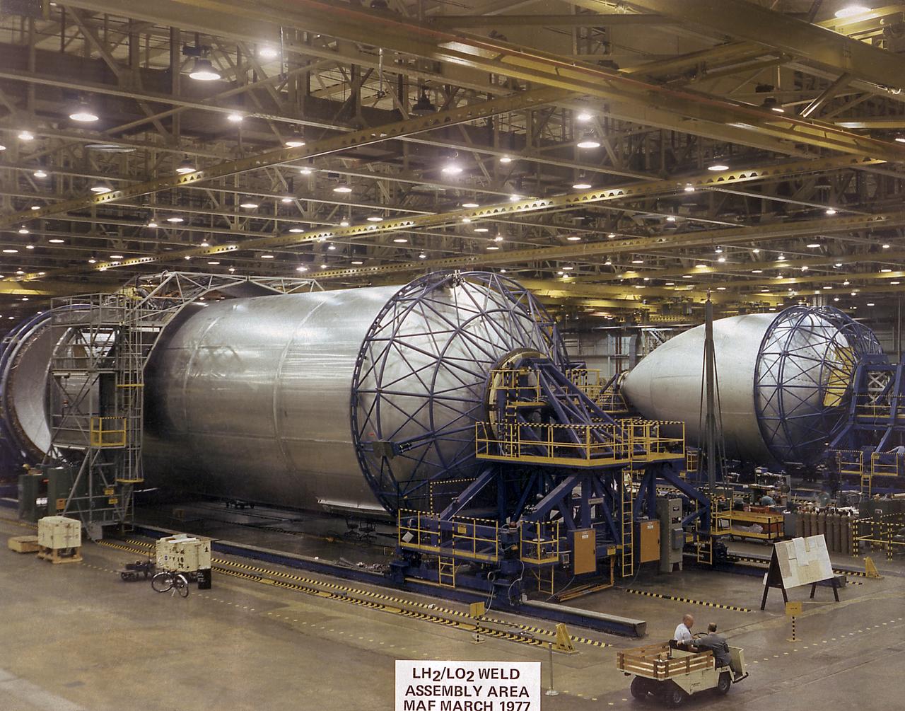 This photograph shows the liquid hydrogen tank and liquid oxygen tank for the Space Shuttle external tank (ET) being assembled in the weld assembly area of the Michoud Assembly Facility (MAF). The ET provides liquid hydrogen and liquid oxygen to the Shuttle's three main engines during the first eight 8.5 minutes of flight. At 154-feet long and more than 27-feet in diameter, the ET is the largest component of the Space Shuttle, the structural backbone of the entire Shuttle system, and the only part of the vehicle that is not reusable. The ET is manufactured at the Michoud Assembly Facility near New Orleans, Louisiana, by the Martin Marietta Corporation under management of the Marshall Space Flight Center.