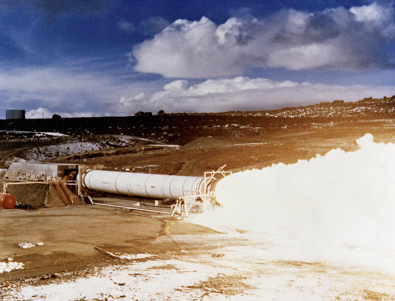 Pictured is an early testing of the Solid Rocket Motor (SRM) at the Thiokol facility in Utah. The SRMs later became known as Solid Rocket Boosters (SRBs) as they were more frequently used on the Space Shuttles.