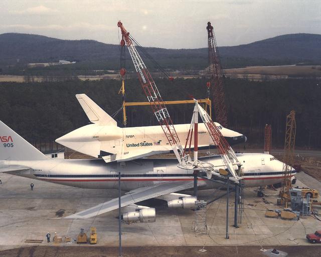The Shuttle Orbiter Enterprise is off-loaded at Redstone Arsenal Airfield for later Mated Vertical Ground Vibration tests (MVGVT) at Marshall Space Flight Center's Dynamic Test Stand. The tests marked the first time ever that the entire shuttle complement (including orbiter, external tank, and solid rocket boosters) were mated vertically.