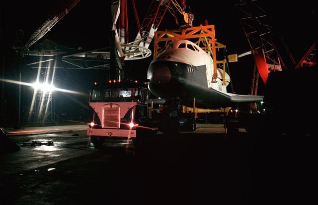 The Shuttle Orbiter Enterprise is off-loaded at Redstone Arsenal Airfield for later Mated Vertical Ground Vibration tests (MVGVT) at Marshall Space Flight Center's Dynamic Test Stand. The tests marked the first time ever that the entire shuttle complement including orbiter, external tank, and solid rocket boosters were vertically mated.