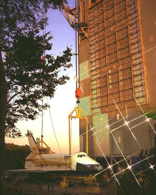 This is a double exposure of the Shuttle Orbiter Enterprise on the strong back of the Dynamic Test Stand at Marshall Space Flight Center's building 4550 as it undergoes a Mated Vertical Ground Vibration Test (MVGVT). One exposure depicts a sunset view, while the other depicts a post-sunset view.