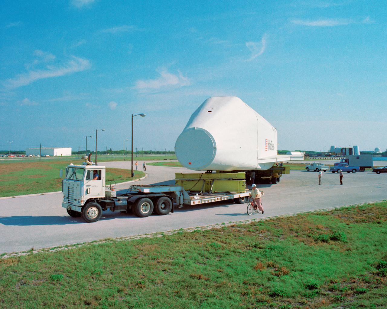 CAPE CANAVERAL, Fla. – At NASA's Kennedy Space Center in Florida, the space shuttle mock-up, dubbed Pathfinder, makes its trek from the turn basin to the Vehicle Assembly Building on April 5, 1978. The mock-up, constructed at NASA's Marshall Space Flight Center in Huntsville, Ala., possessed the general dimensions, weight and balance of a real space shuttle. It was shipped to Kennedy by barge and then used to fit-check the work platforms of the Mate-Demate Device, orbiter processing facilities and Vehicle Assembly Building, as well as support ground crew training. It also was used to rehearse post-landing procedures at Kennedy's Shuttle Landing Facility.  After being on display at the 'Great Space Shuttle Exposition' in Tokyo from June 1983 to August 1984, the mock-up returned to Marshall and now is on permanent display at the U.S. Space and Rocket Center near Huntsville. Photo credit: NASA