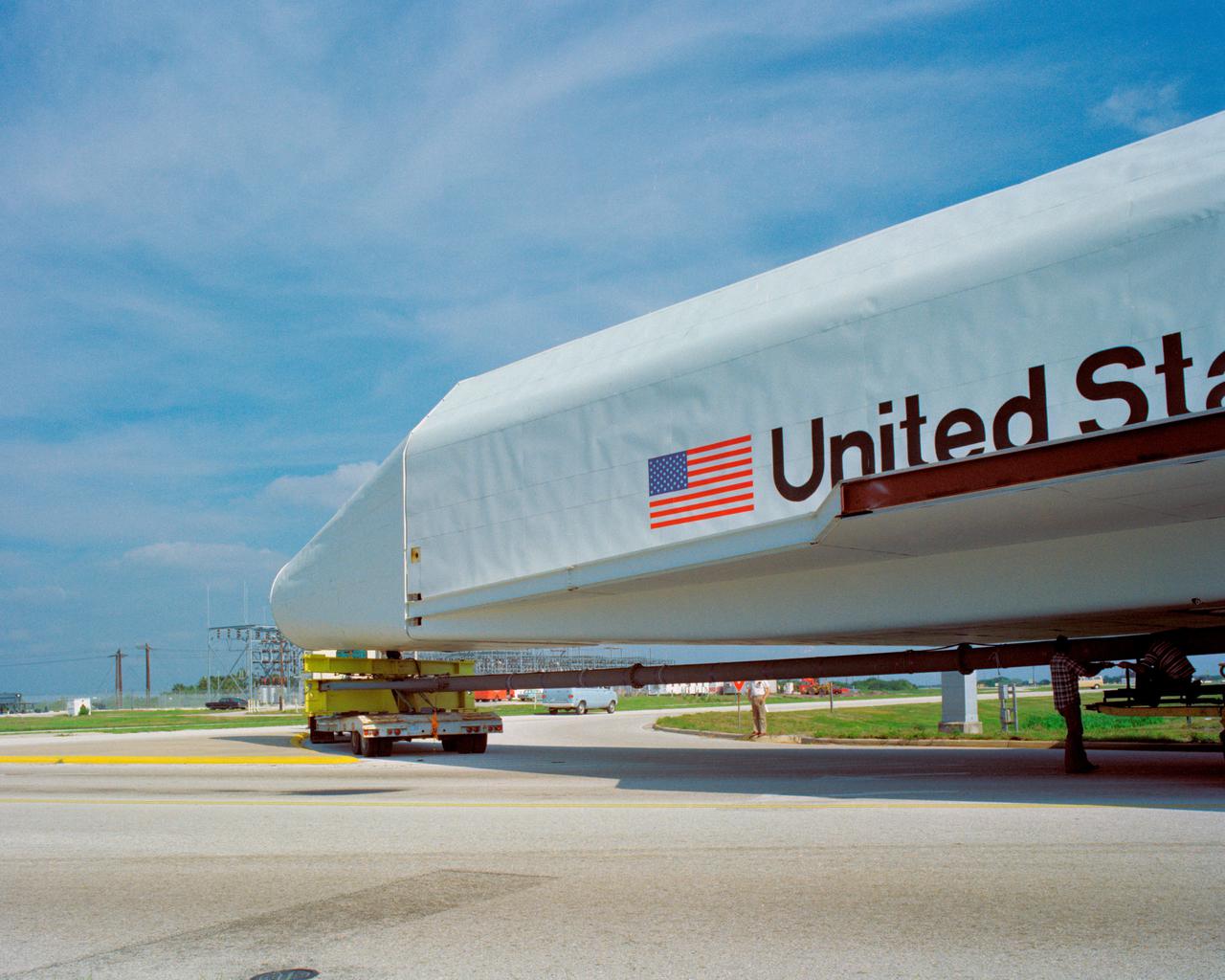 CAPE CANAVERAL, Fla. – At NASA's Kennedy Space Center in Florida, the space shuttle mock-up, dubbed Pathfinder, makes its trek from the turn basin to the Vehicle Assembly Building on April 5, 1978. The mock-up, constructed at NASA's Marshall Space Flight Center in Huntsville, Ala., possessed the general dimensions, weight and balance of a real space shuttle. It was shipped to Kennedy by barge and then used to fit-check the work platforms of the Mate-Demate Device, orbiter processing facilities and Vehicle Assembly Building, as well as support ground crew training. It also was used to rehearse post-landing procedures at Kennedy's Shuttle Landing Facility.  After being on display at the 'Great Space Shuttle Exposition' in Tokyo from June 1983 to August 1984, the mock-up returned to Marshall and now is on permanent display at the U.S. Space and Rocket Center near Huntsville. Photo credit: NASA