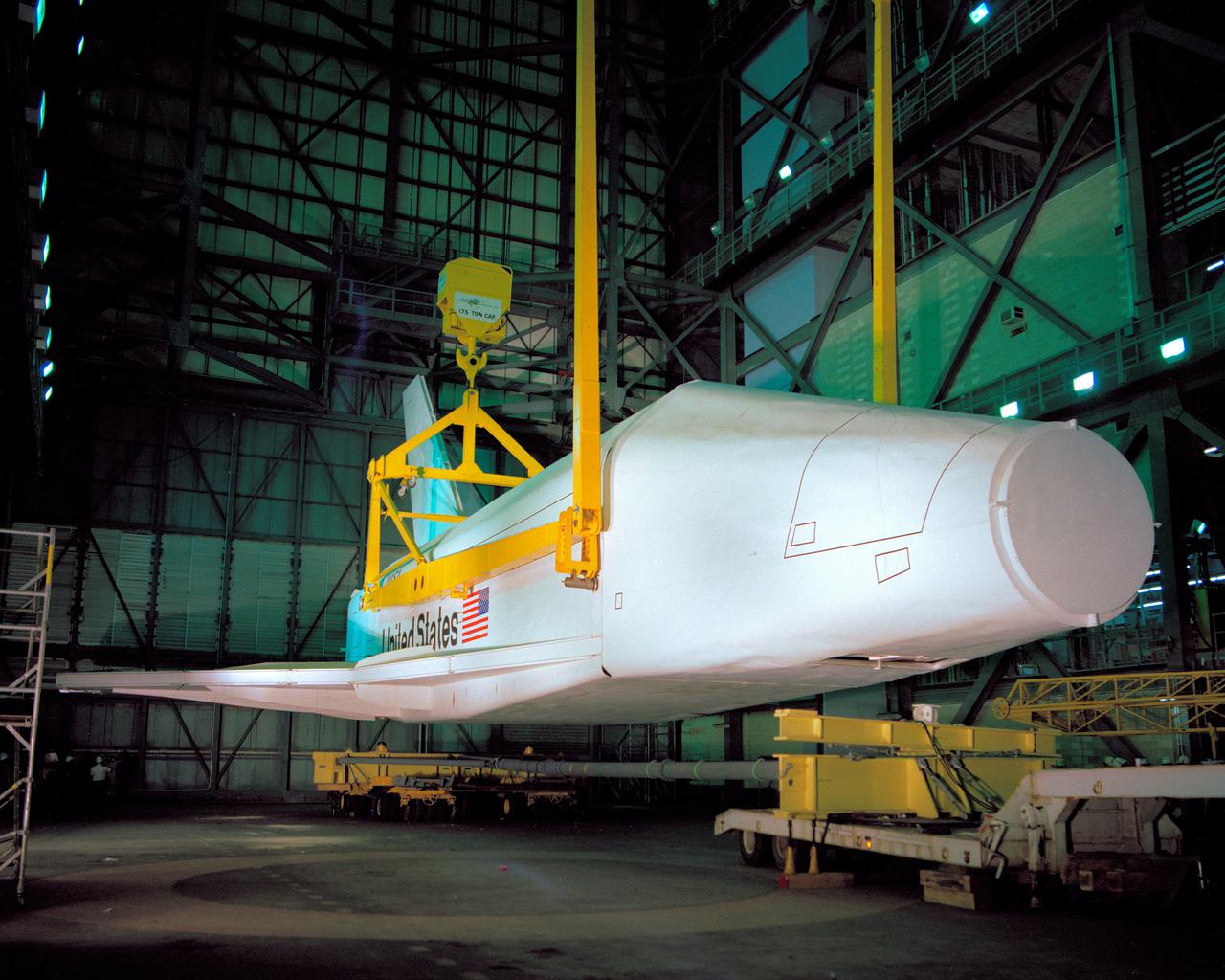 CAPE CANAVERAL, Fla. – At NASA's Kennedy Space Center in Florida, the space shuttle mock-up, dubbed Pathfinder, performs a lift test in the Vehicle Assembly Building on May 31, 1978. The mock-up, constructed at NASA's Marshall Space Flight Center in Huntsville, Ala., possessed the general dimensions, weight and balance of a real space shuttle. It was shipped to Kennedy by barge and then used to fit-check the work platforms of the Mate-Demate Device, orbiter processing facilities and Vehicle Assembly Building, as well as support ground crew training. It also was used to rehearse post-landing procedures at Kennedy's Shuttle Landing Facility.  After being on display at the 'Great Space Shuttle Exposition' in Tokyo from June 1983 to August 1984, the mock-up returned to Marshall and now is on permanent display at the U.S. Space and Rocket Center near Huntsville. Photo credit: NASA