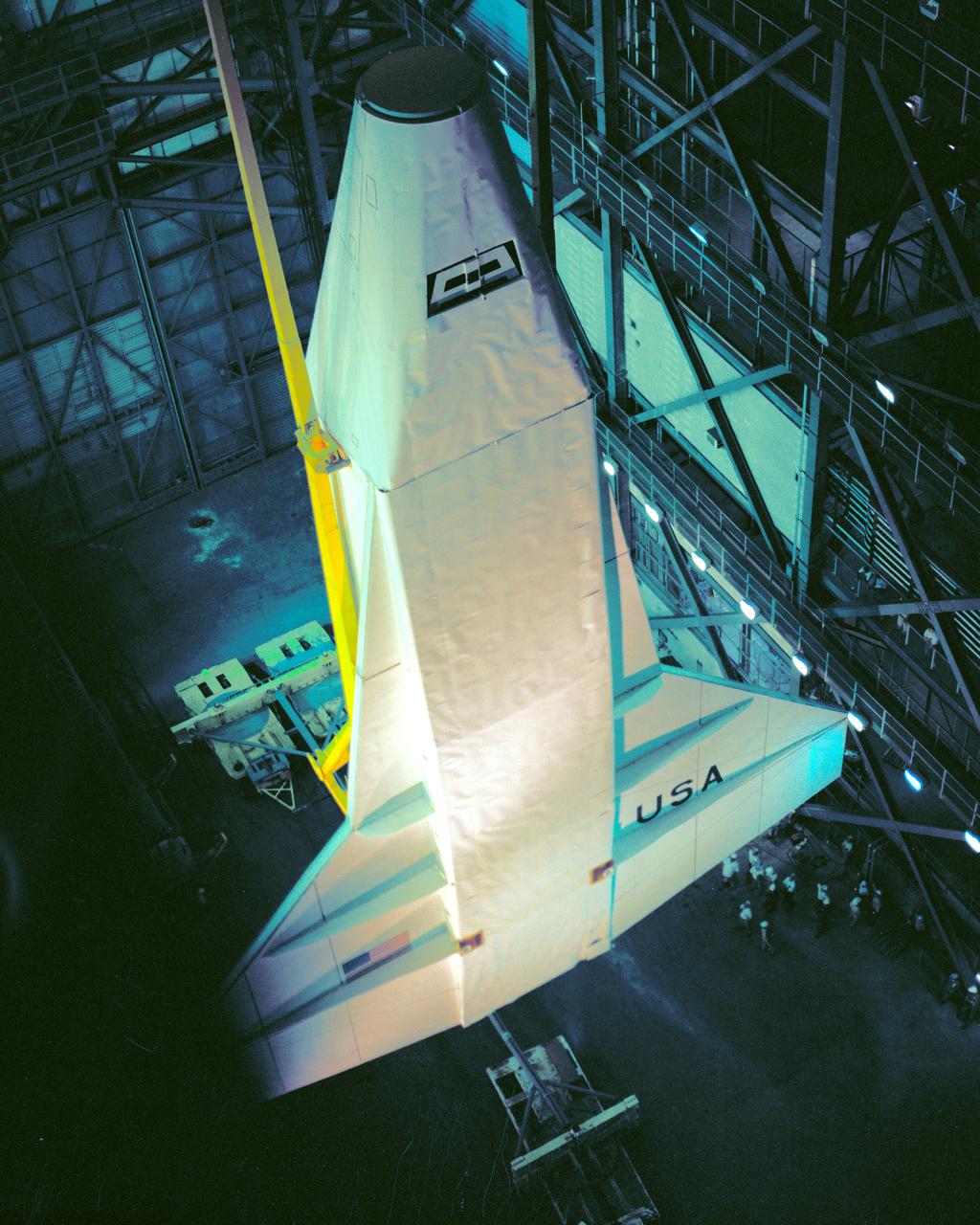 CAPE CANAVERAL, Fla. – At NASA's Kennedy Space Center in Florida, the space shuttle mock-up, dubbed Pathfinder, undergoes a lift test in the Vehicle Assembly Building on May 31, 1978. The mock-up, constructed at NASA's Marshall Space Flight Center in Huntsville, Ala., possessed the general dimensions, weight and balance of a real space shuttle. It was shipped to Kennedy by barge and then used to fit-check the work platforms of the Mate-Demate Device, orbiter processing facilities and Vehicle Assembly Building, as well as support ground crew training. It also was used to rehearse post-landing procedures at Kennedy's Shuttle Landing Facility.  After being on display at the 'Great Space Shuttle Exposition' in Tokyo from June 1983 to August 1984, the mock-up returned to Marshall and now is on permanent display at the U.S. Space and Rocket Center near Huntsville. Photo credit: NASA