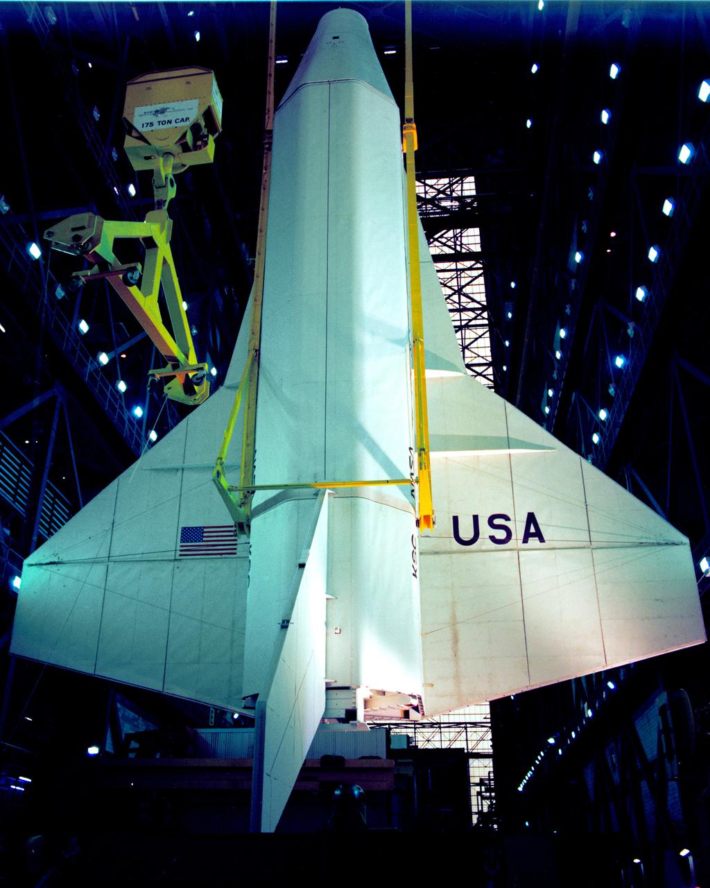 CAPE CANAVERAL, Fla. – At NASA's Kennedy Space Center in Florida, the space shuttle mock-up, dubbed Pathfinder, undergoes a lift test in the Vehicle Assembly Building on May 31, 1978. The mock-up, constructed at NASA's Marshall Space Flight Center in Huntsville, Ala., possessed the general dimensions, weight and balance of a real space shuttle. It was shipped to Kennedy by barge and then used to fit-check the work platforms of the Mate-Demate Device, orbiter processing facilities and Vehicle Assembly Building, as well as support ground crew training. It also was used to rehearse post-landing procedures at Kennedy's Shuttle Landing Facility.  After being on display at the 'Great Space Shuttle Exposition' in Tokyo from June 1983 to August 1984, the mock-up returned to Marshall and now is on permanent display at the U.S. Space and Rocket Center near Huntsville. Photo credit: NASA